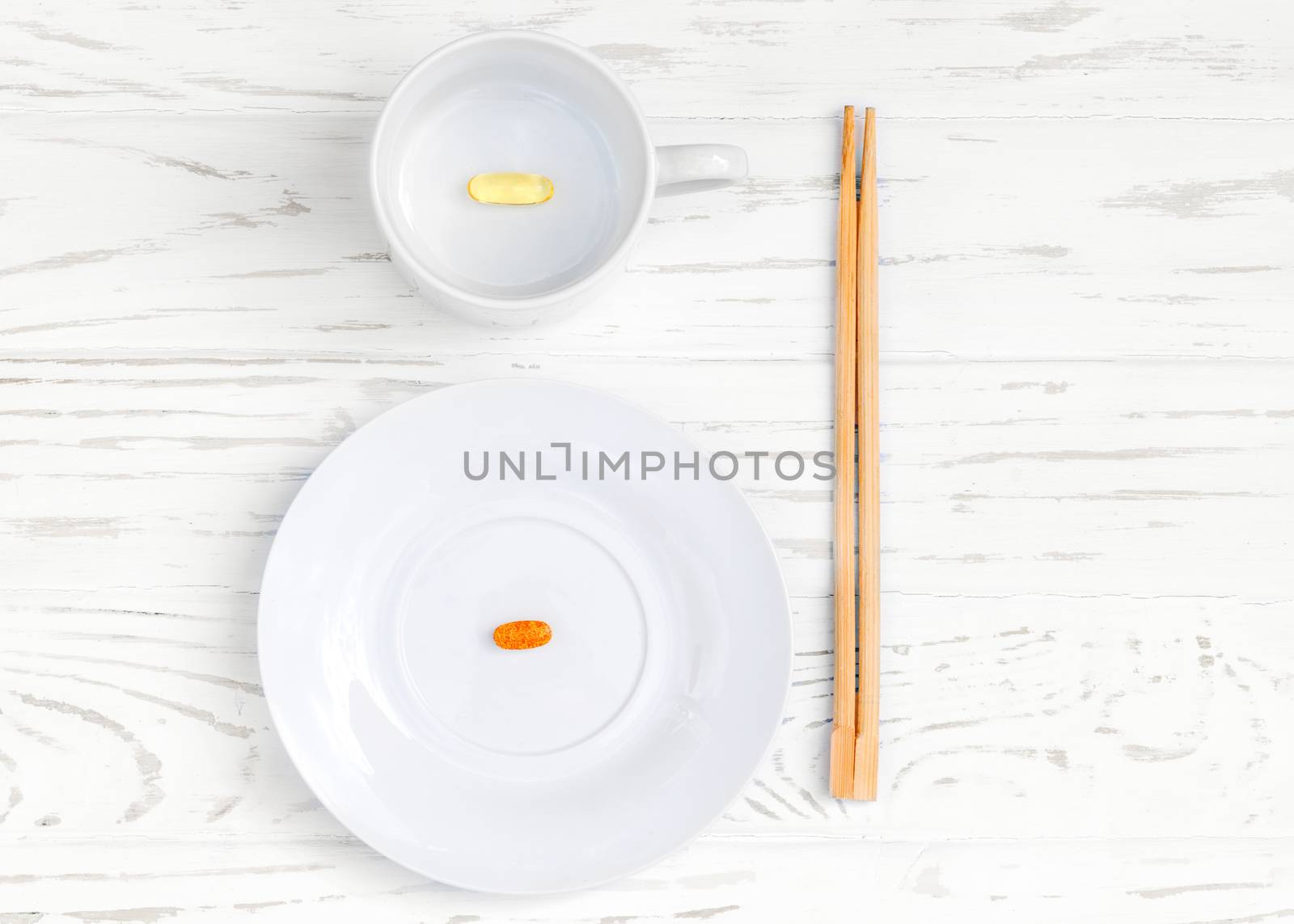 white plate and cup with food additives and chopsticks