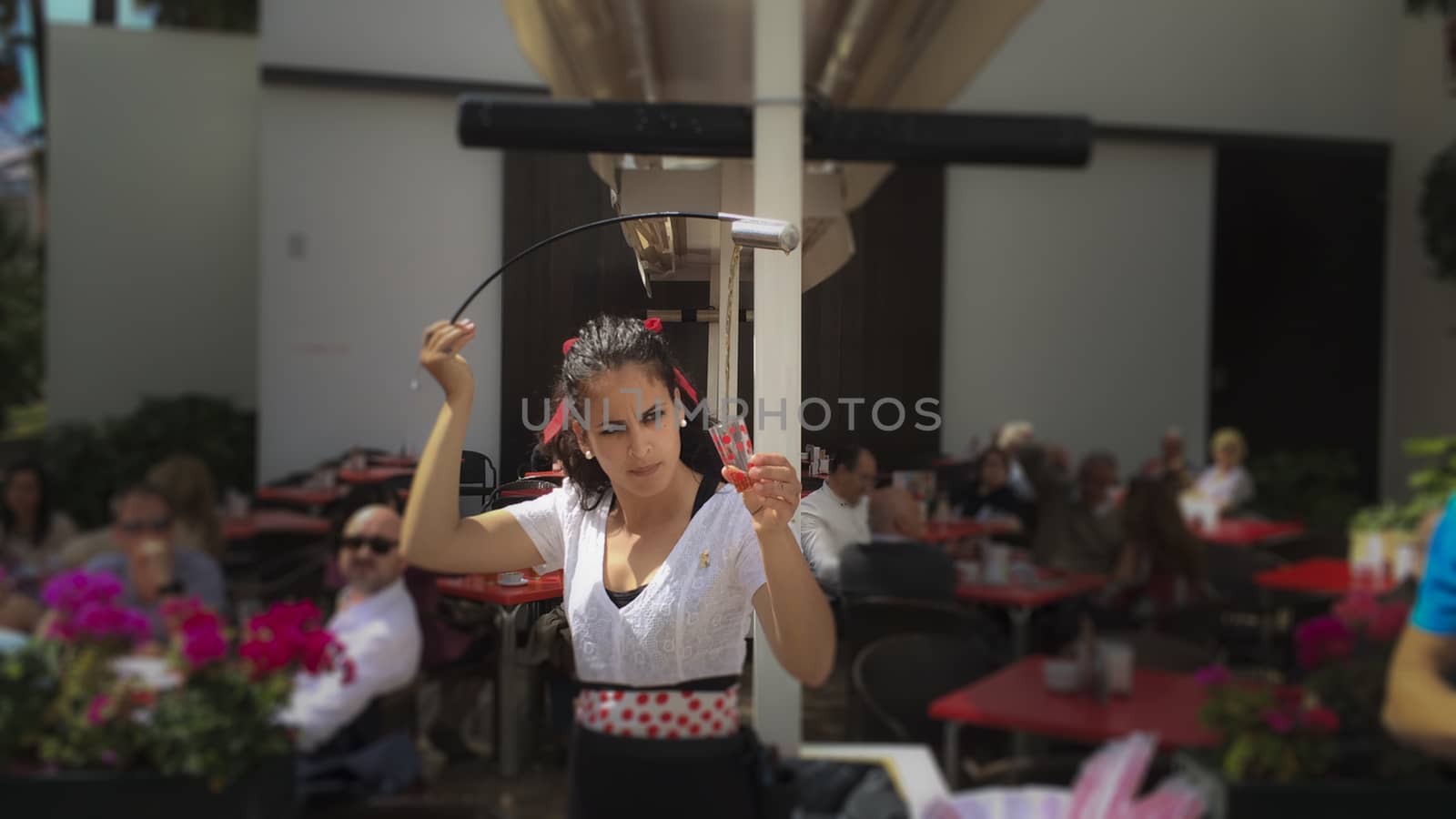 waitress serving and pouring Sherry, a traditional habit called Venenciar in Malaga, Spain by kb79