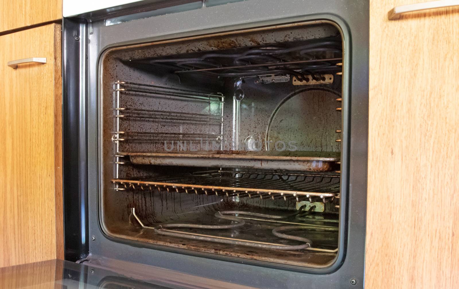 Antique kitchen with dirty oven by michaklootwijk