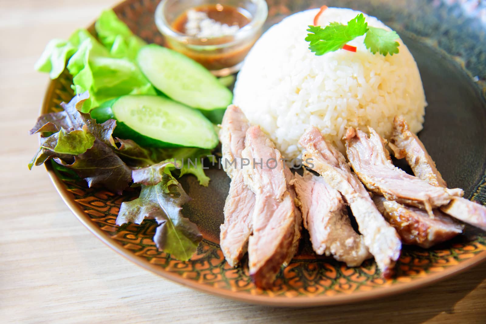 Roast pork with spicy souce rice on table