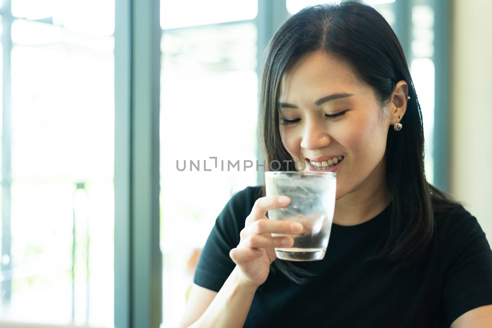 An Asian beautiful woman has drinking a water in the morning. by animagesdesign