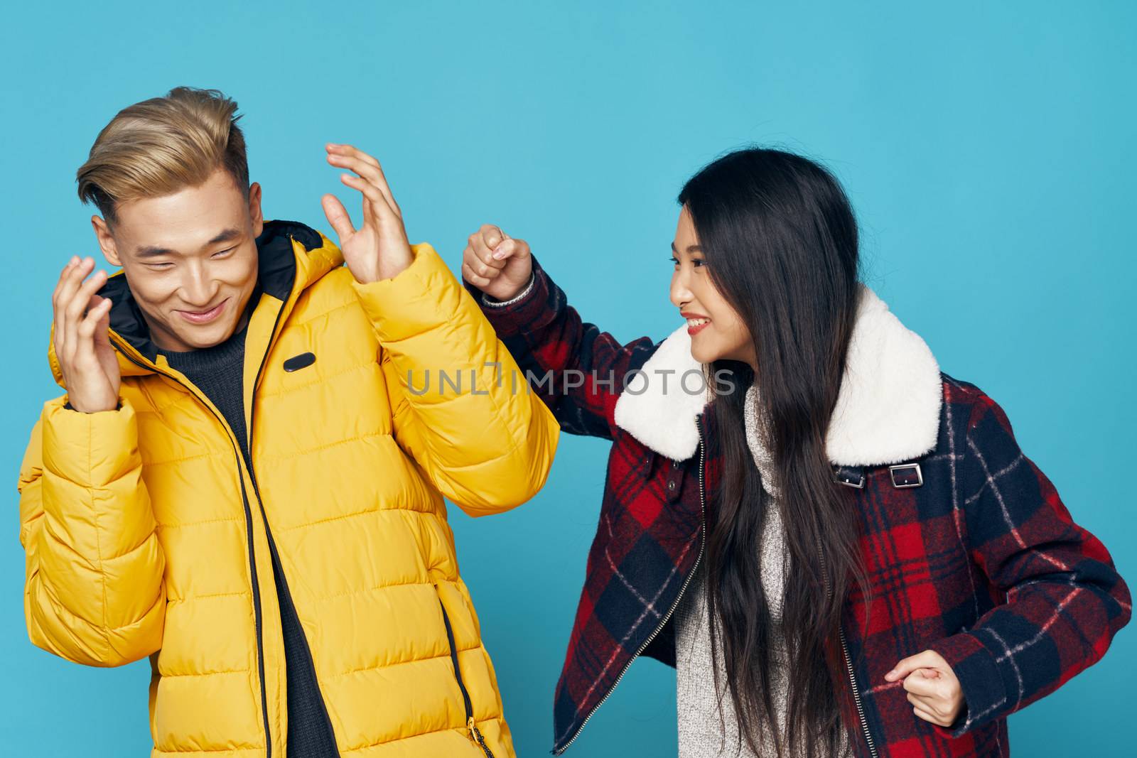 funny young people in fashionable clothes laughing on isolated background