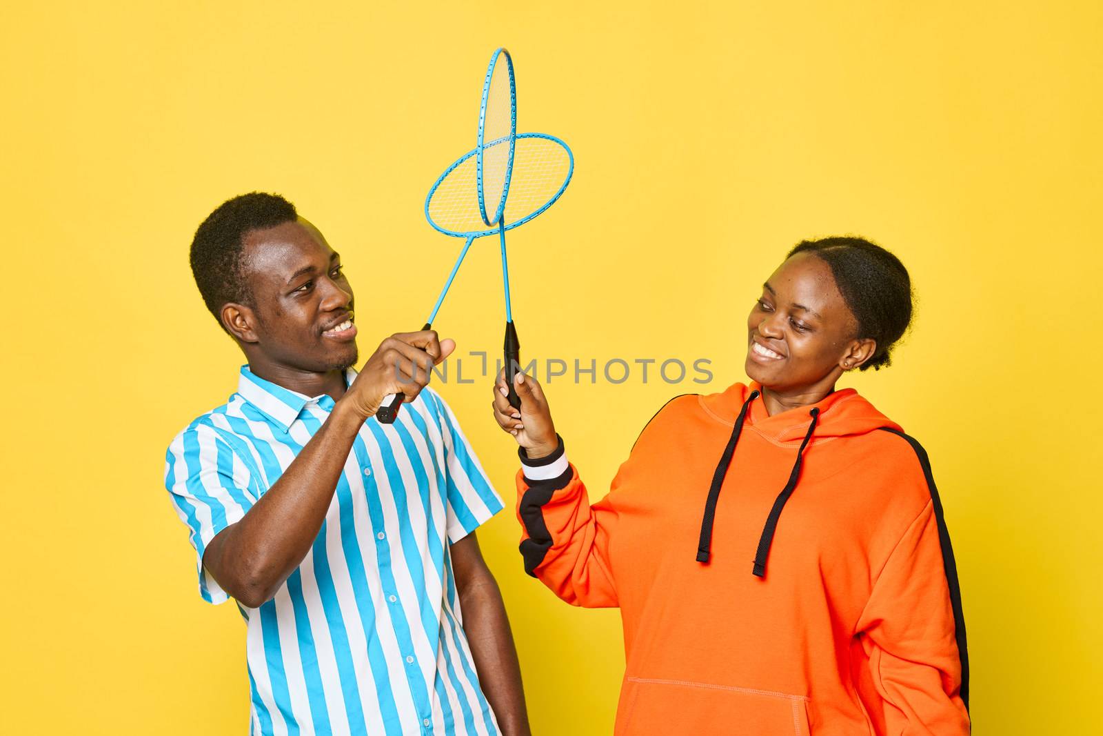 A man and woman of African appearance play badminton by SHOTPRIME