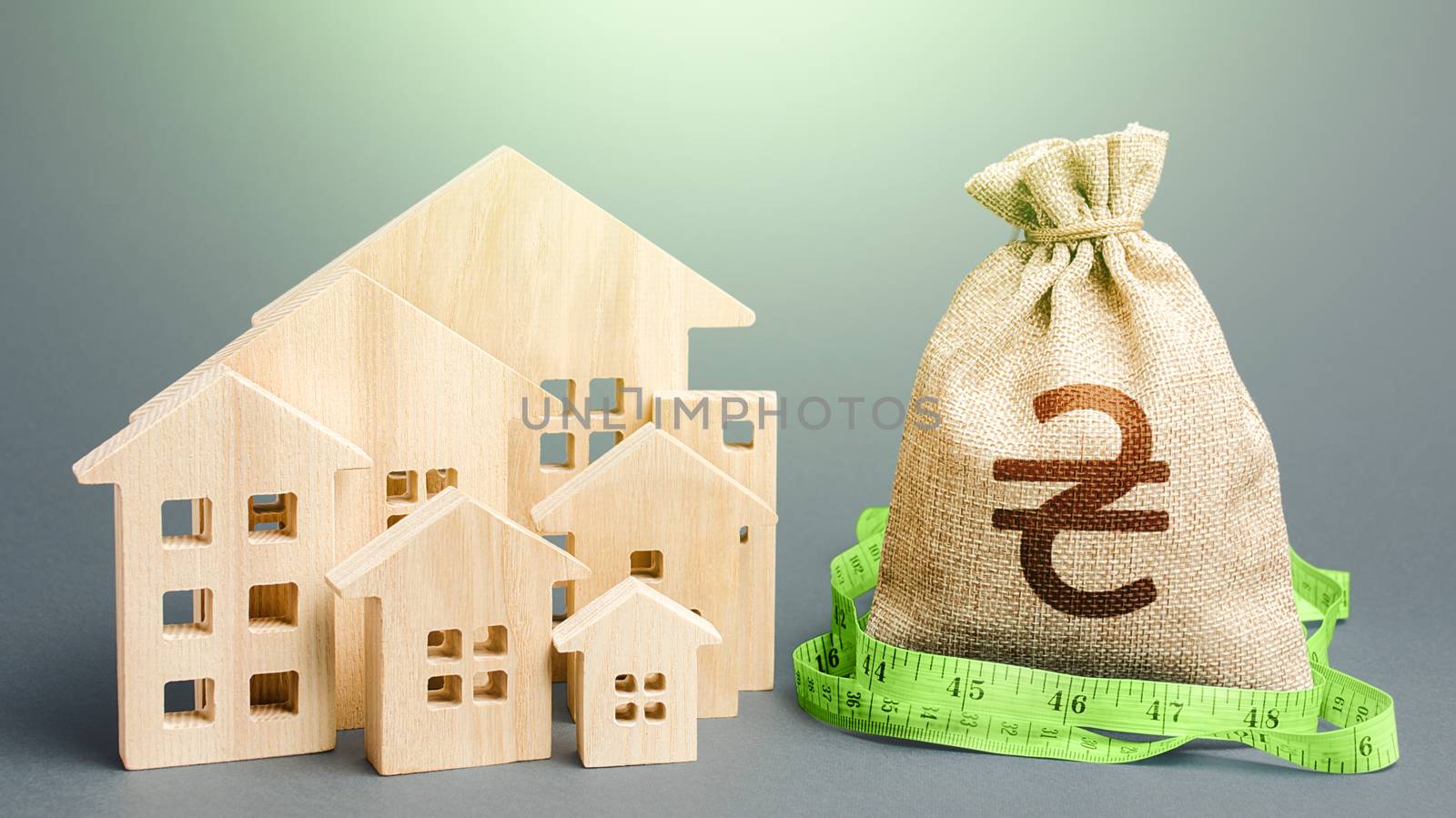 Residential houses and a ukrainian hryvnia money bag. Mortgage loan. Buying, fair price. Property real estate valuation. Calculation of construction and repair expenses. City municipal budget.