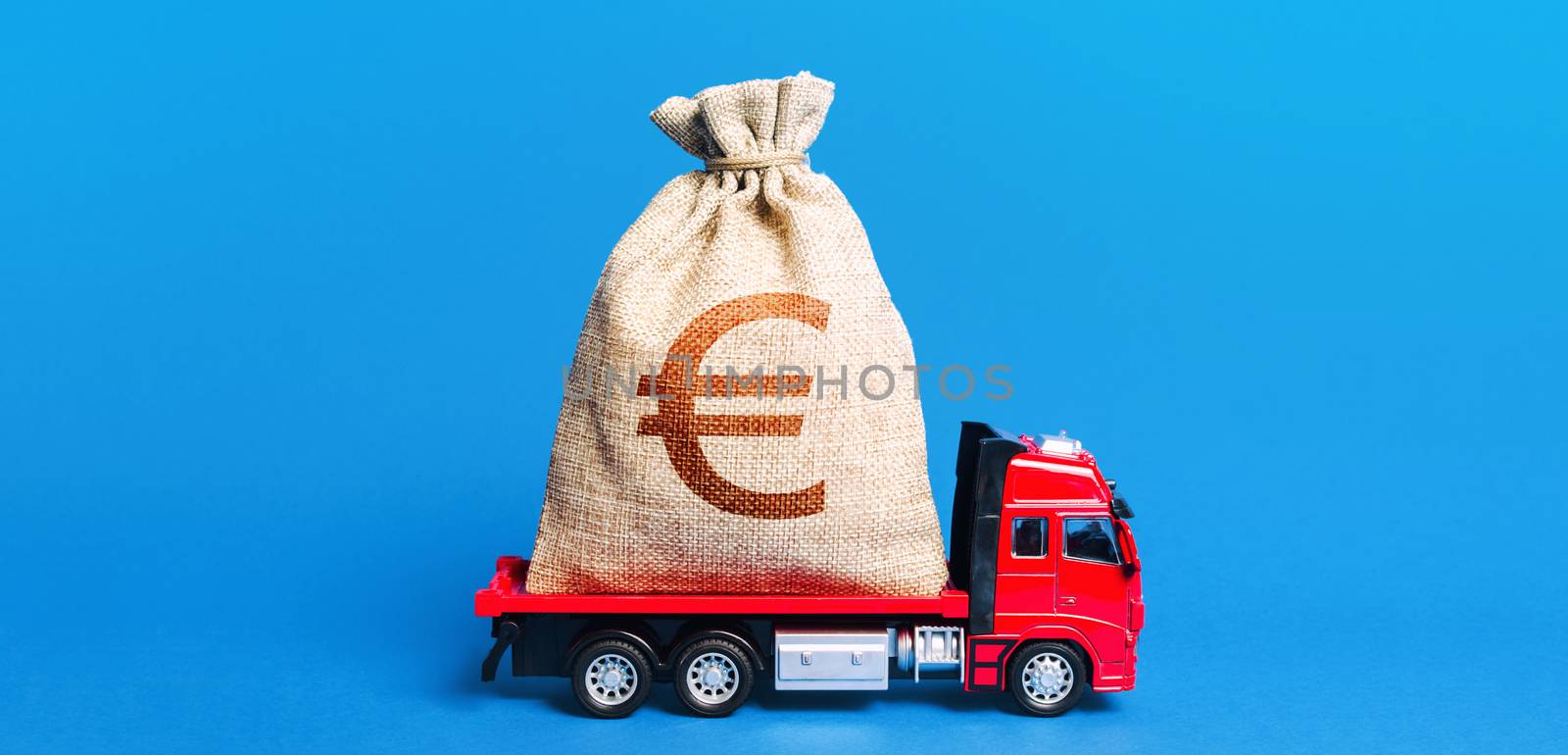 The truck is carrying a huge euro money bag. Great investment. Anti-crisis measures of government. Attracting large funds to the economy for subsidies, support and cheap soft loans for businesses.