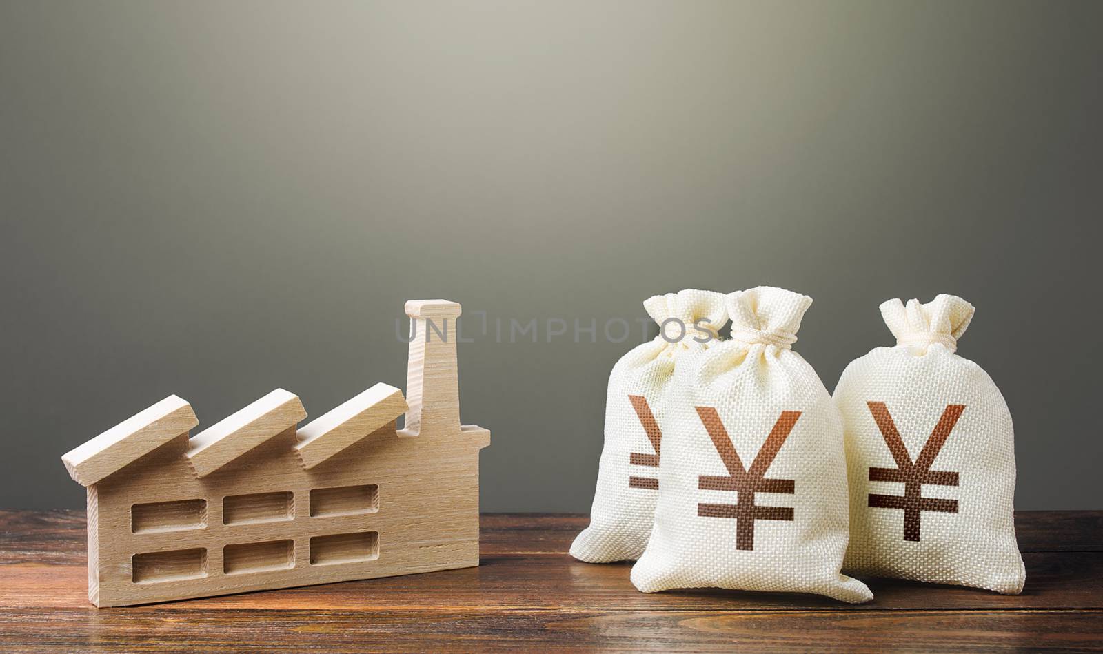 Yen Yuan money bags and industrial factory plant. Privatization and purchase of industrial complexes. Investment modernization, automation, reduction of the impact on environment. Supporting economy.