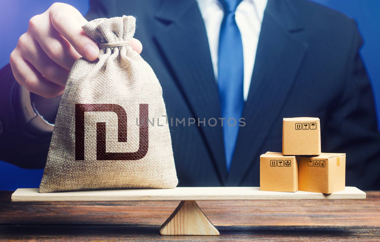 Israeli shekel money bag and boxes on scales. Trade balance and purchasing power. Import and export duties, profit from the sale of value added goods. Economic and industrial development. VAT