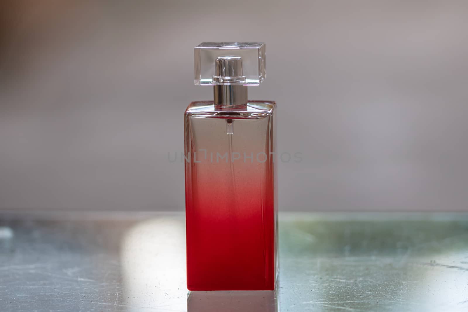 Elegant perfume bottle isolated on blurred background with copy  by vladispas