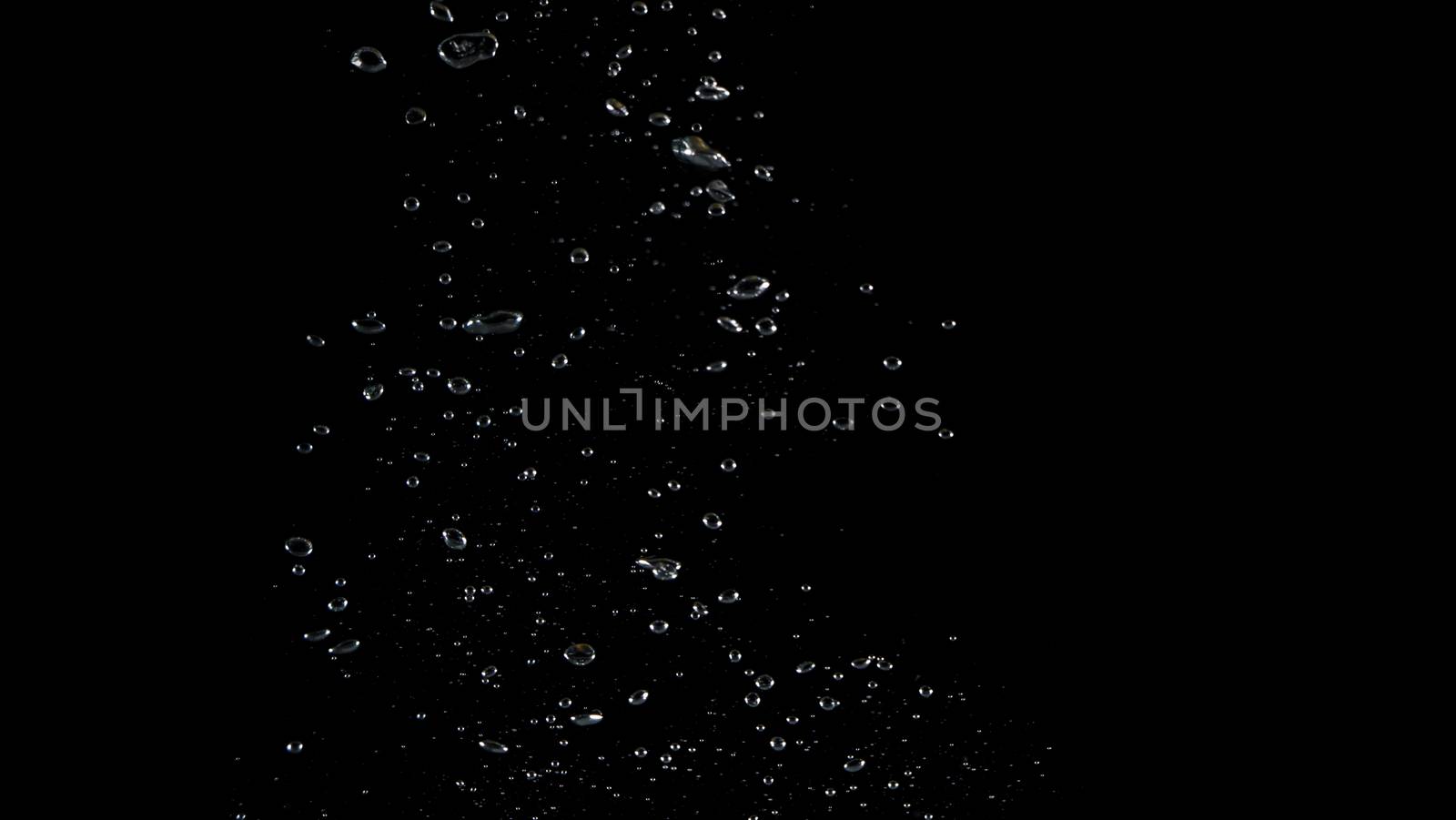 Extream close-up images of water bubbles or soda or liquid texture that splashing and floating up to surface like a explosion in black color background for refreshing carbonate drink concept.