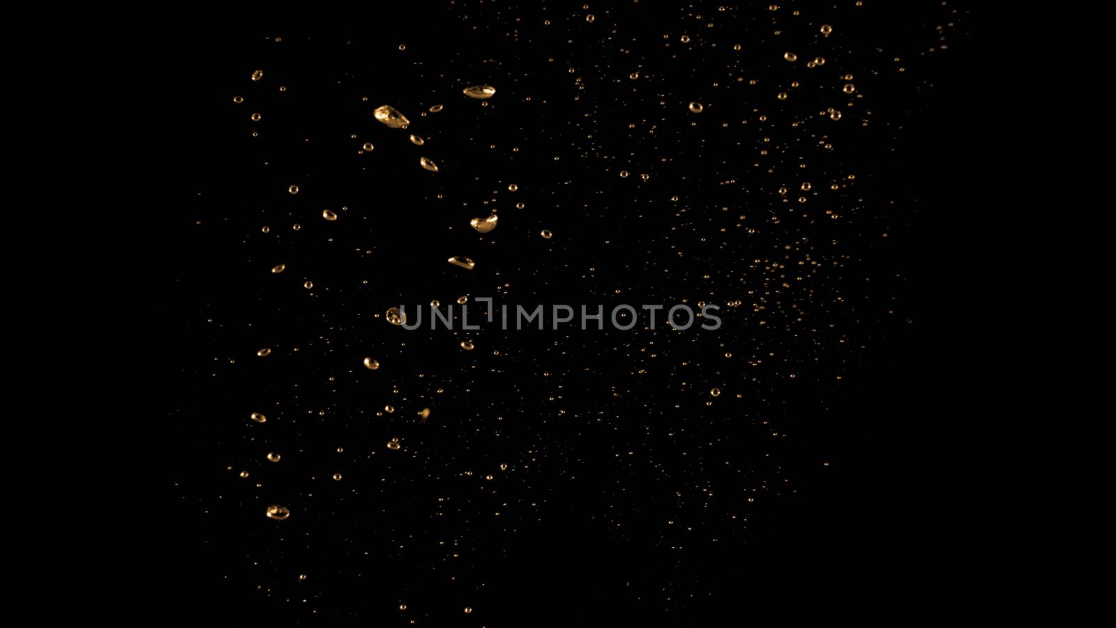 Blurry images of soda bubbles splashing in black background by gnepphoto