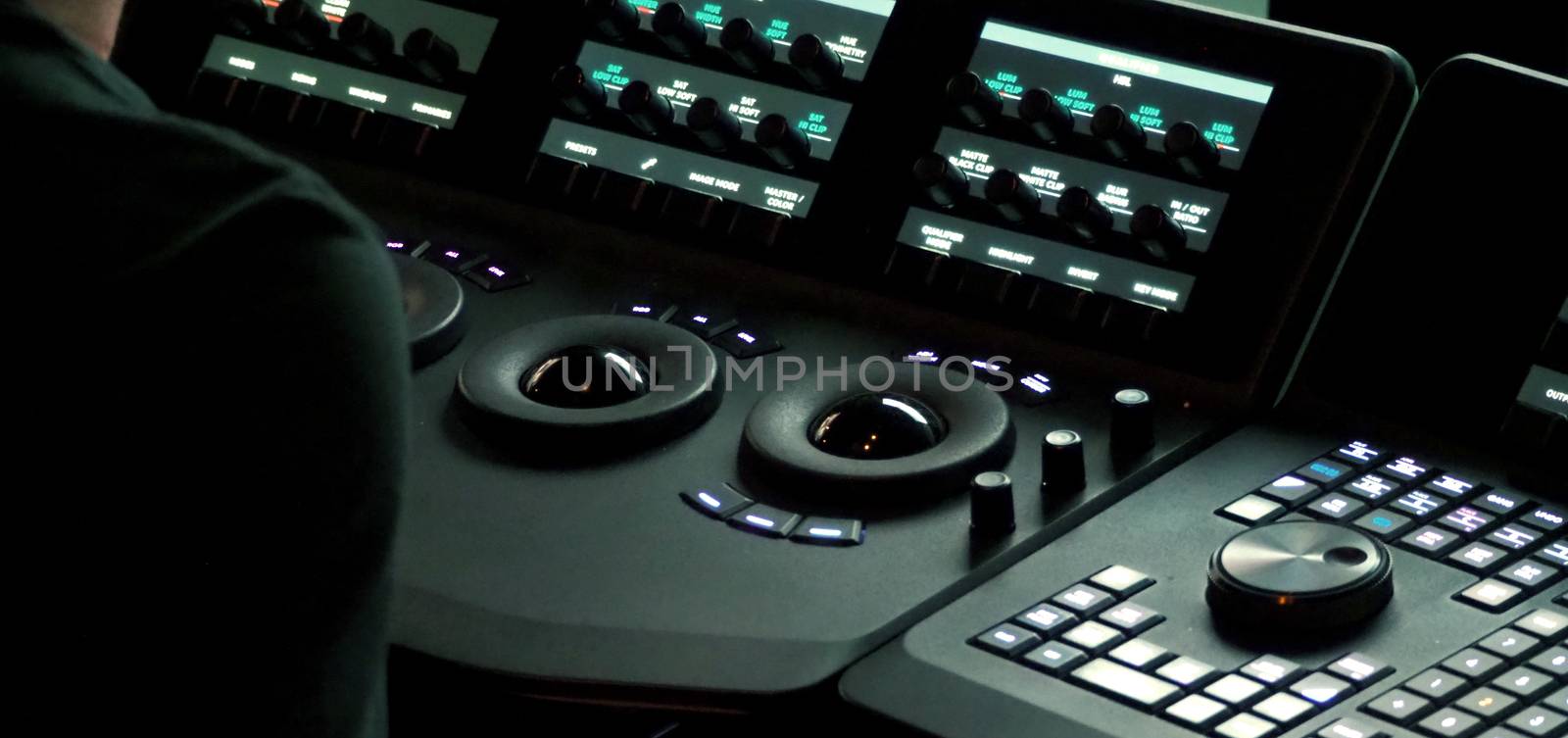 Blurry images of telecine controller machine transferring motion picture film into video and editing or adjusting in a color suite studio lab. which used in the movie post-production process 