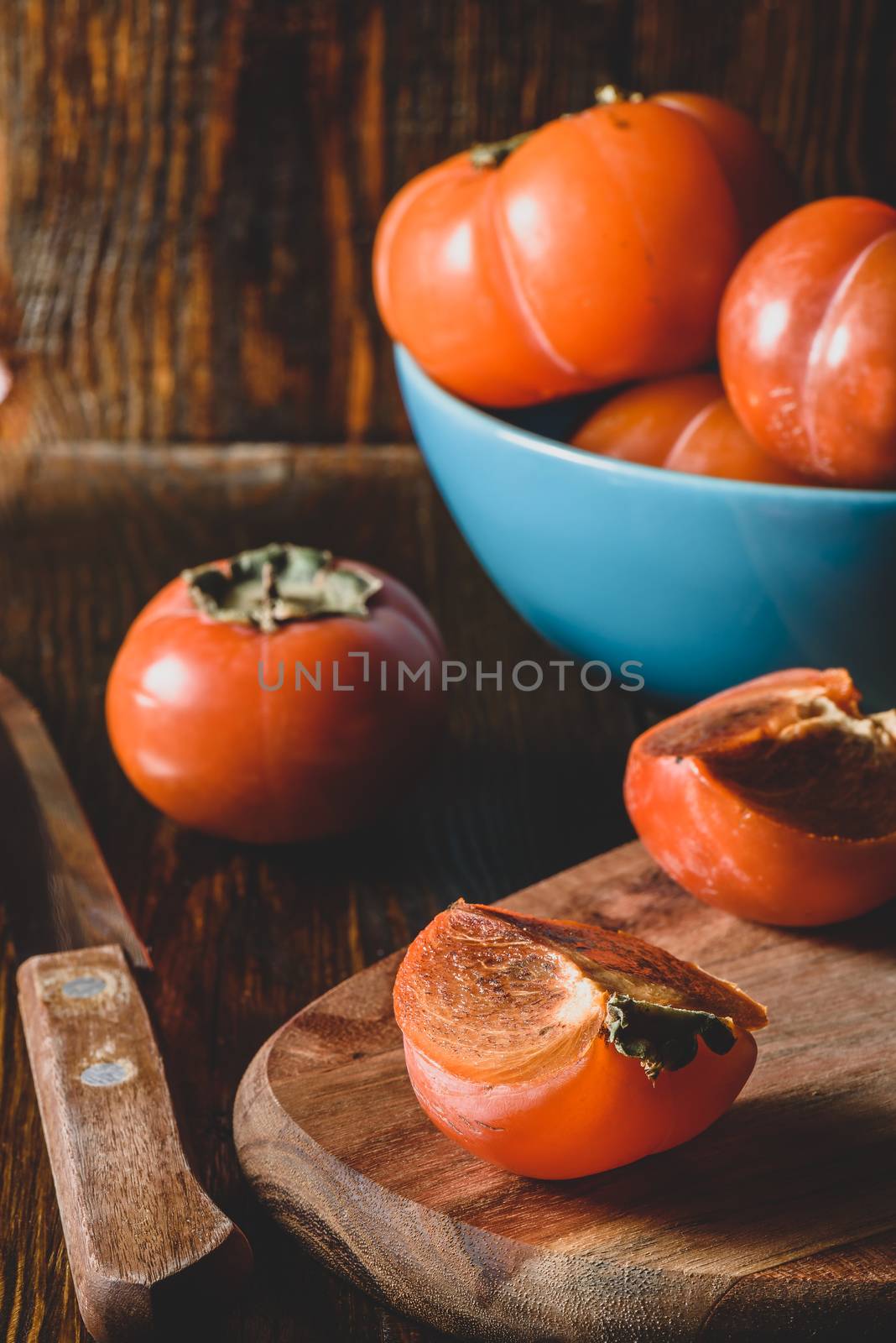 Slices of fresh persimmon on cutting board