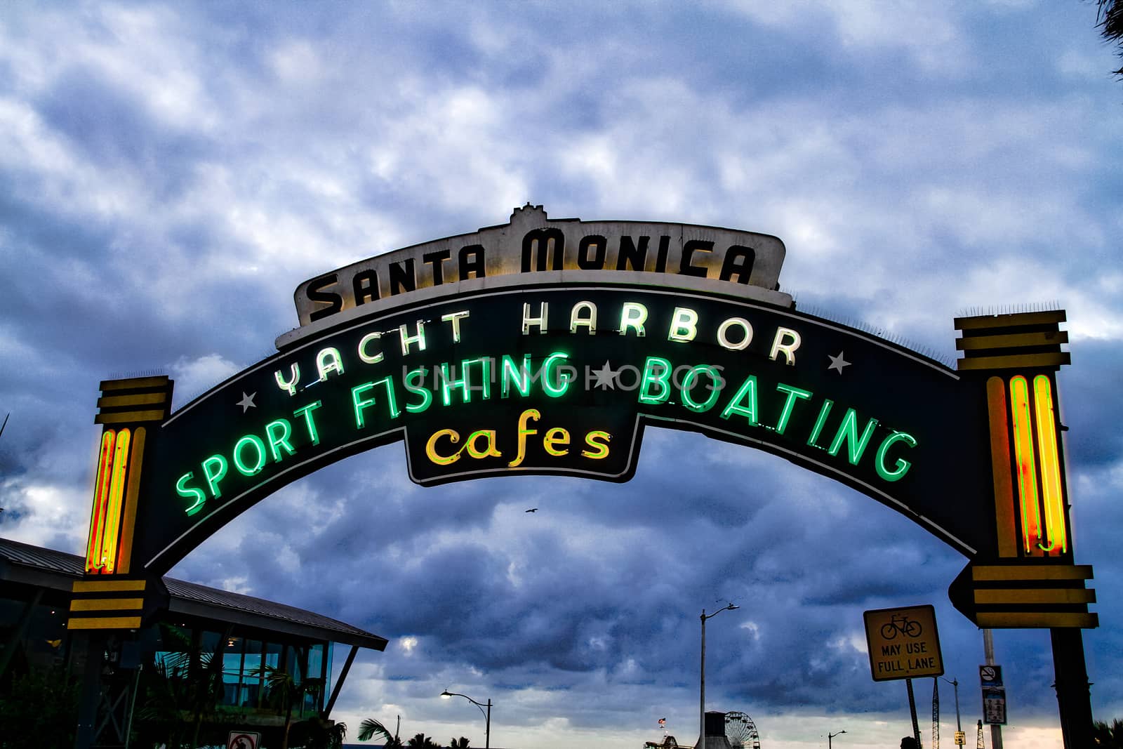 Los Angeles,CA/USA - Oct 29, 2015 : Welcoming arch in Santa Monica, California. The city has 3.5 miles of beach locations.Santa Monica Pier, Picture of the entrance with the famous arch sign. by USA-TARO