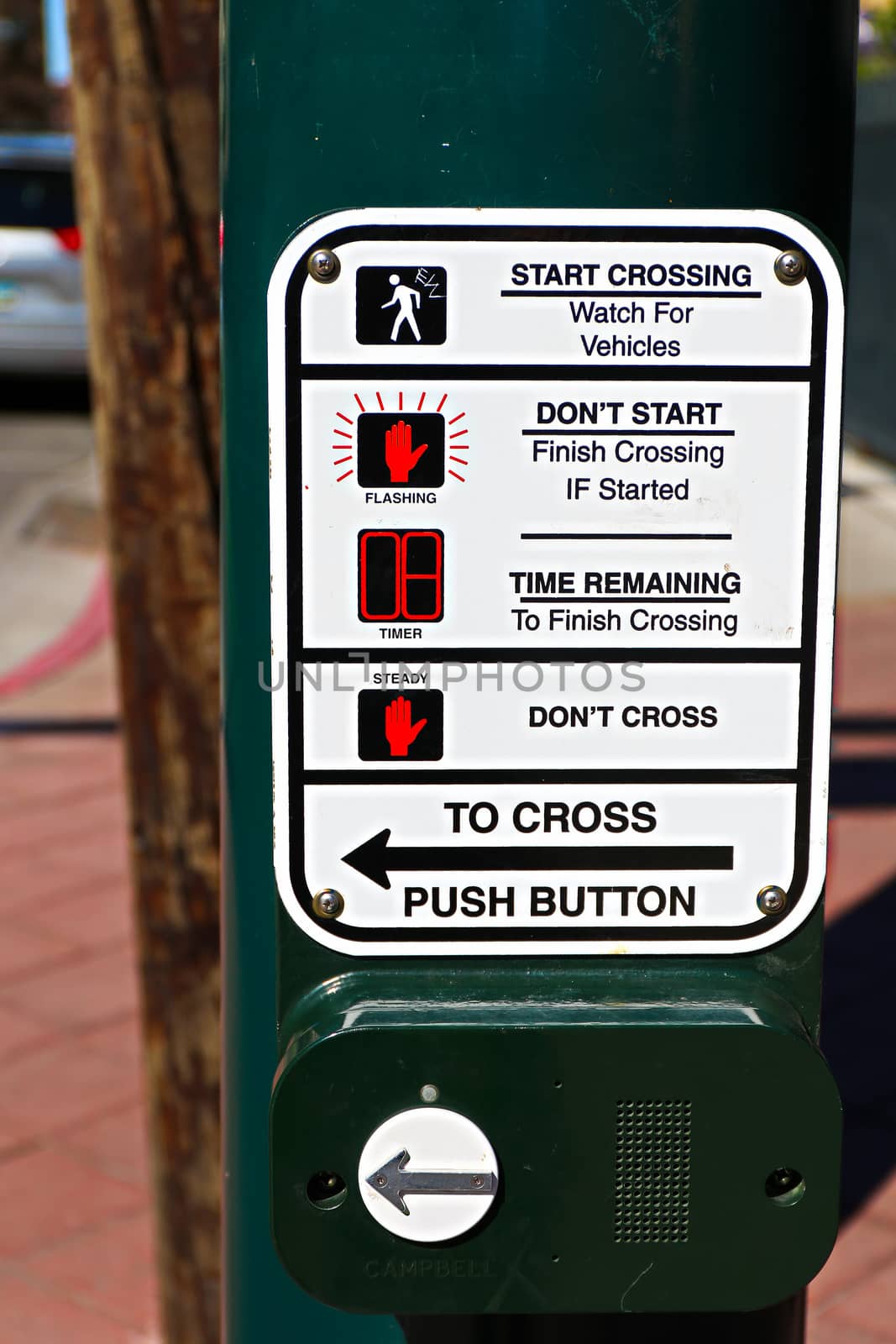 Push button for crossing in crossroad / junction with road blurred background in Los Angeles/USA. by USA-TARO