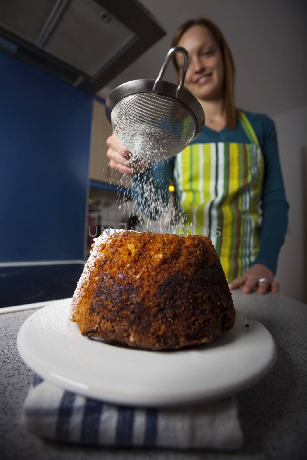 woman with a gugelhupf in a kitchen