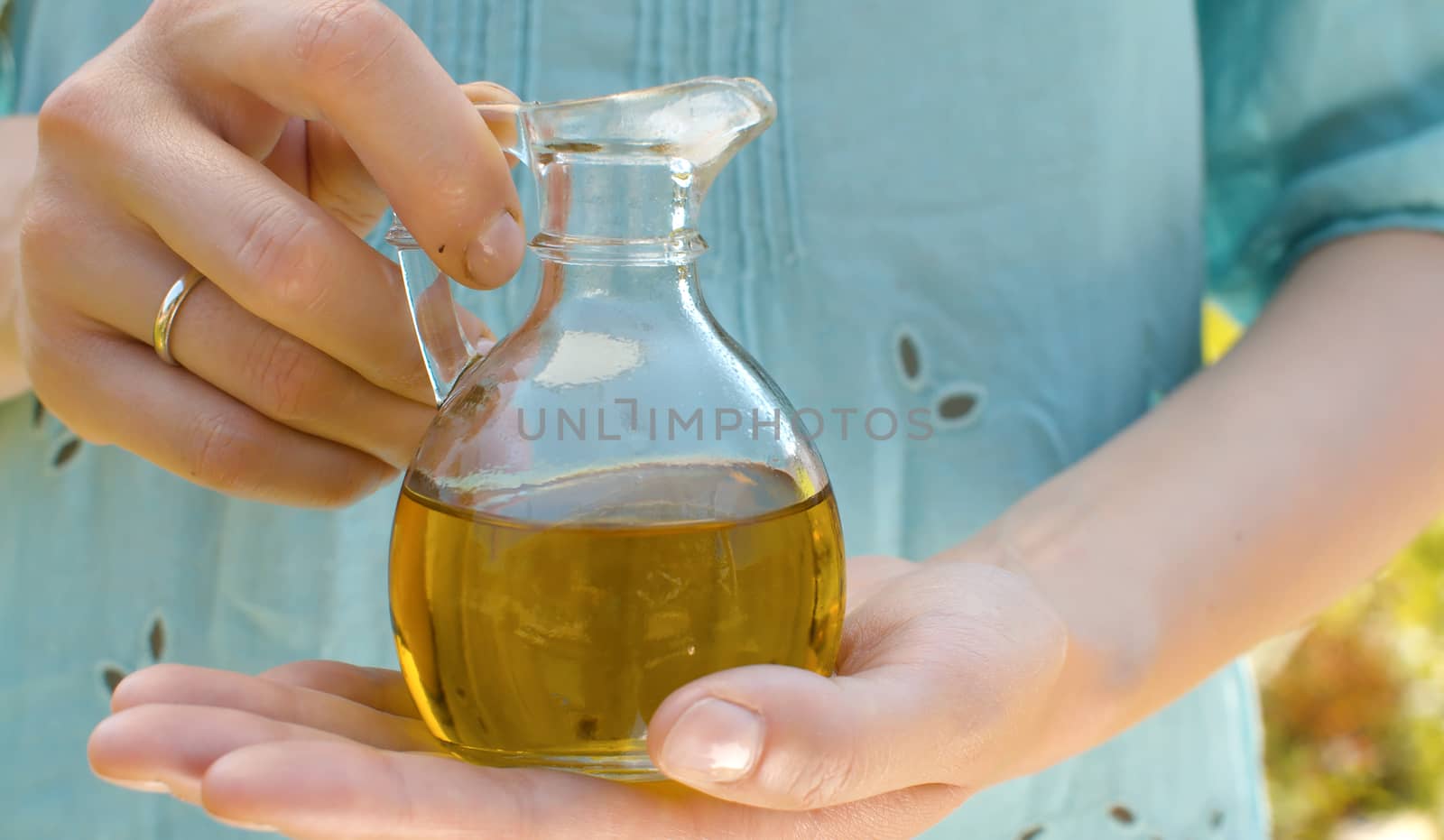 Olive oil in female hands by Alize