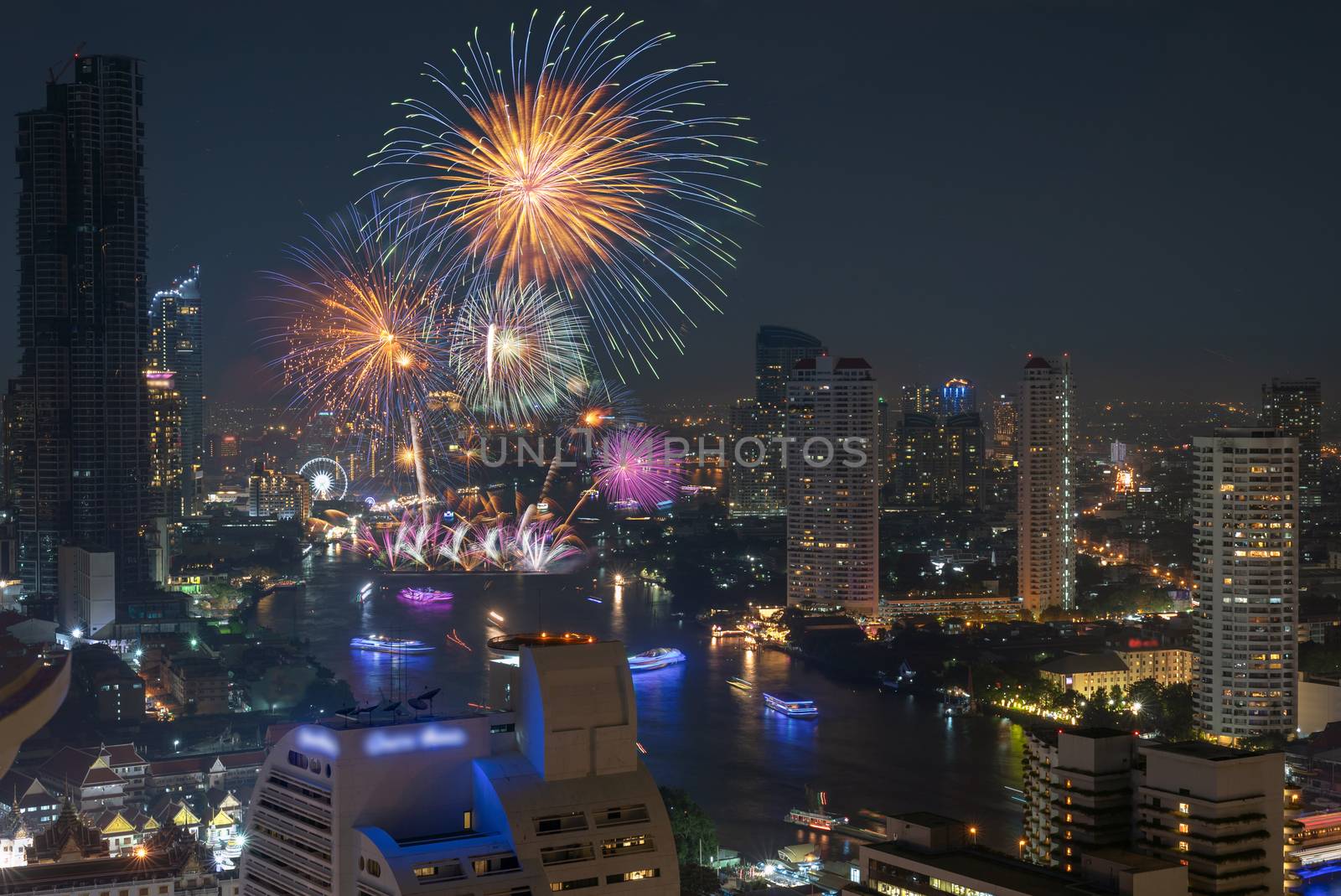 Multicolor Firework exploding over the Bangkok Cityscape river s by Tzido