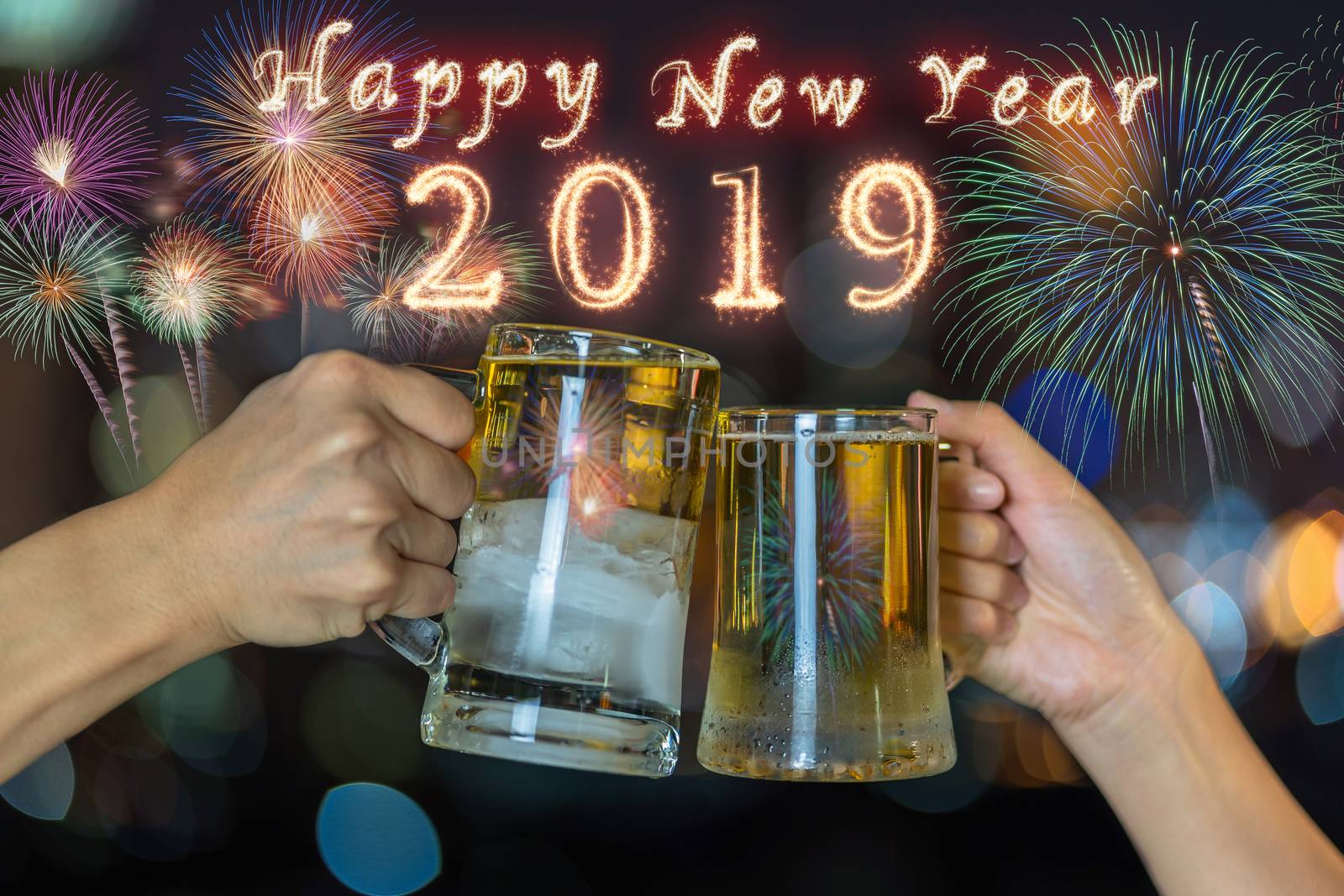 Happy new year 2019 written with Sparkle firework on Clinking with two beer mug or glasses over the photo blurred of cityscape for celebrate, party and celebrate with happy new year concept