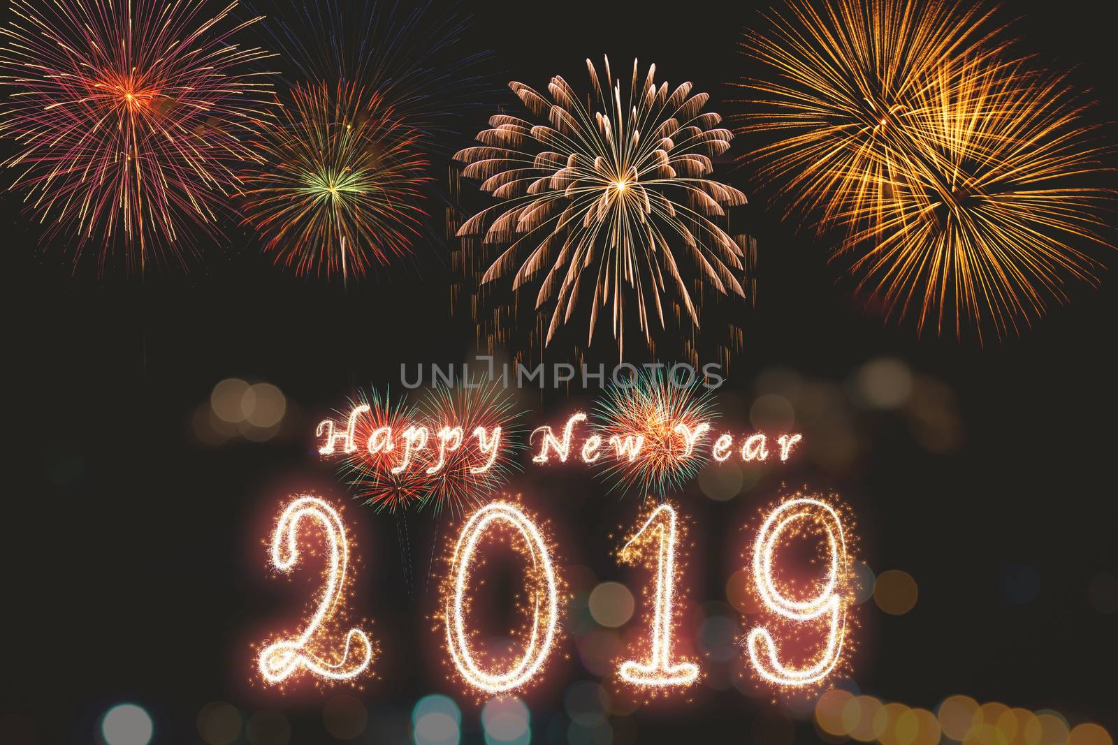 Happy new year 2019 written with Sparkle firework on fireworks with dark background, celebration and greeting cards concept