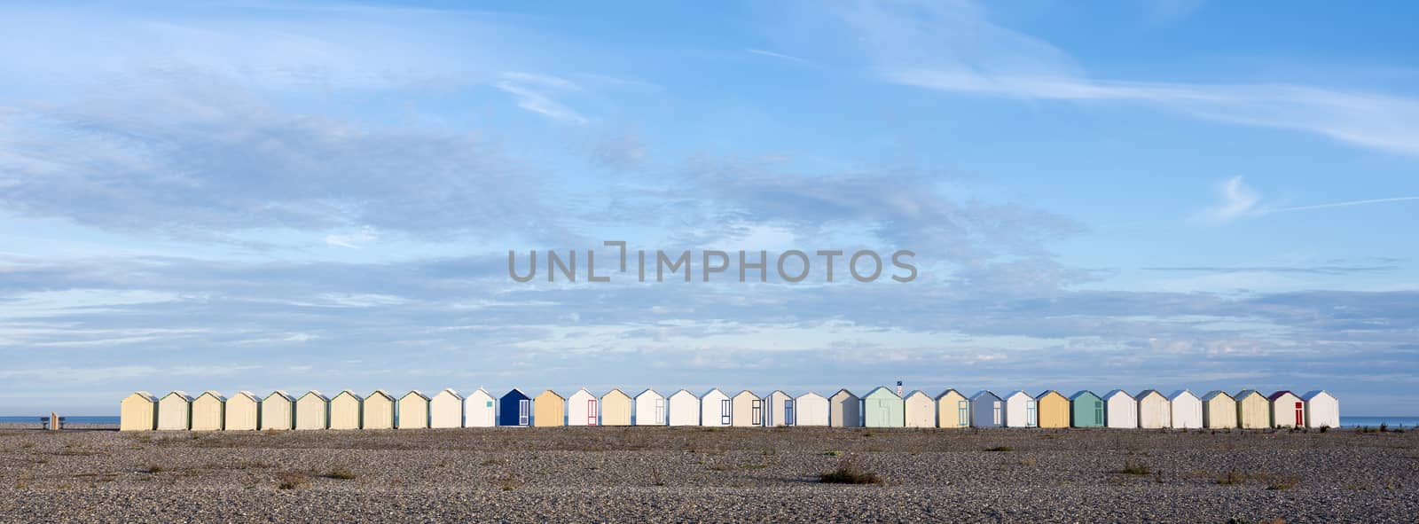 beach huts in cayeux s mer in french normandy under blue sky by ahavelaar