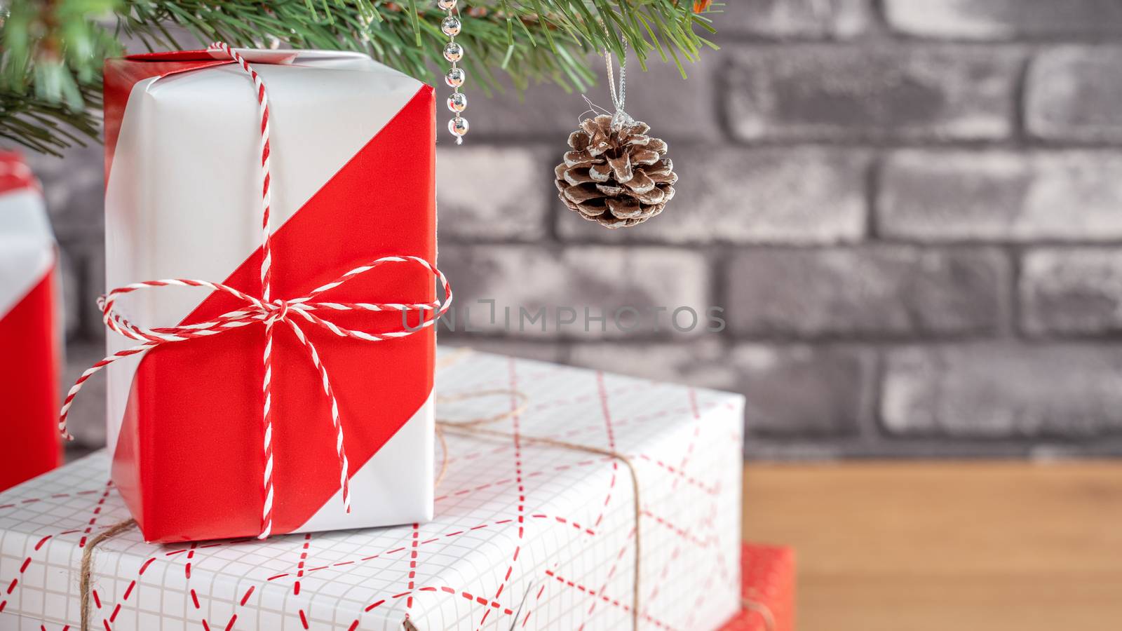 Decorated Christmas tree with wrapped beautiful red and white gi by ROMIXIMAGE