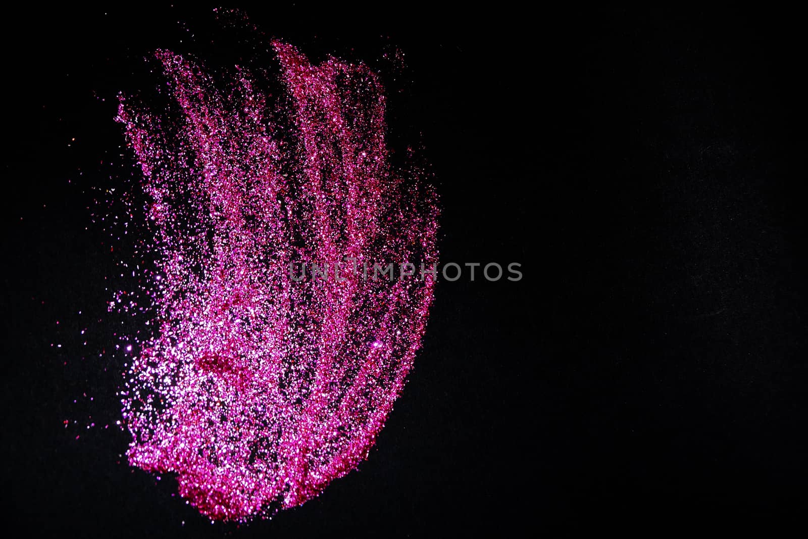 scattering of dark pink shiny glitter on a black background, copy space by Annado