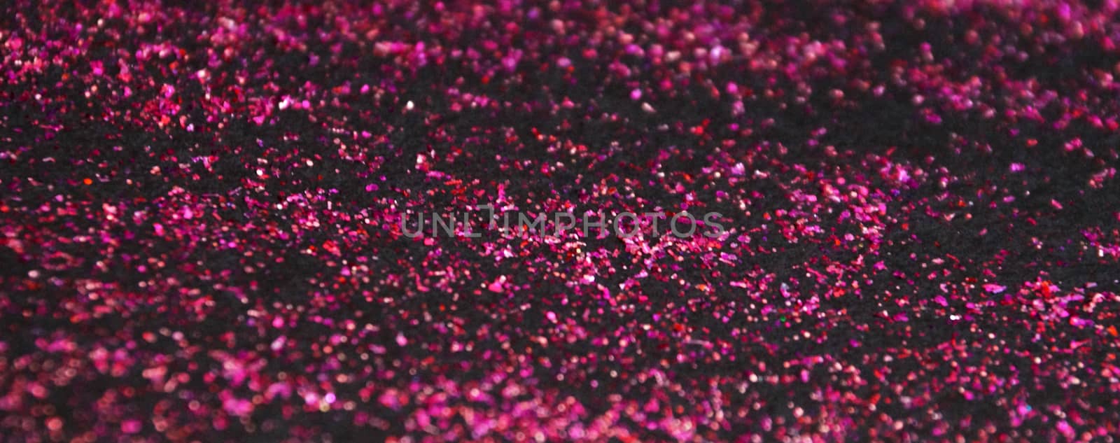 dark pink shiny glitter on black background.