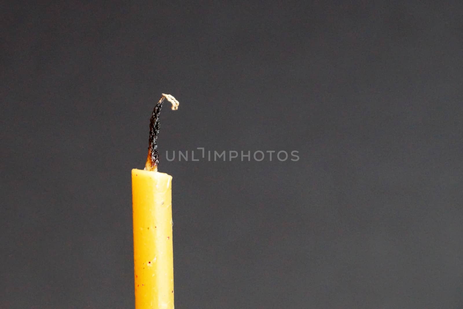 extinguished wax candle on gray background, copy space by Annado