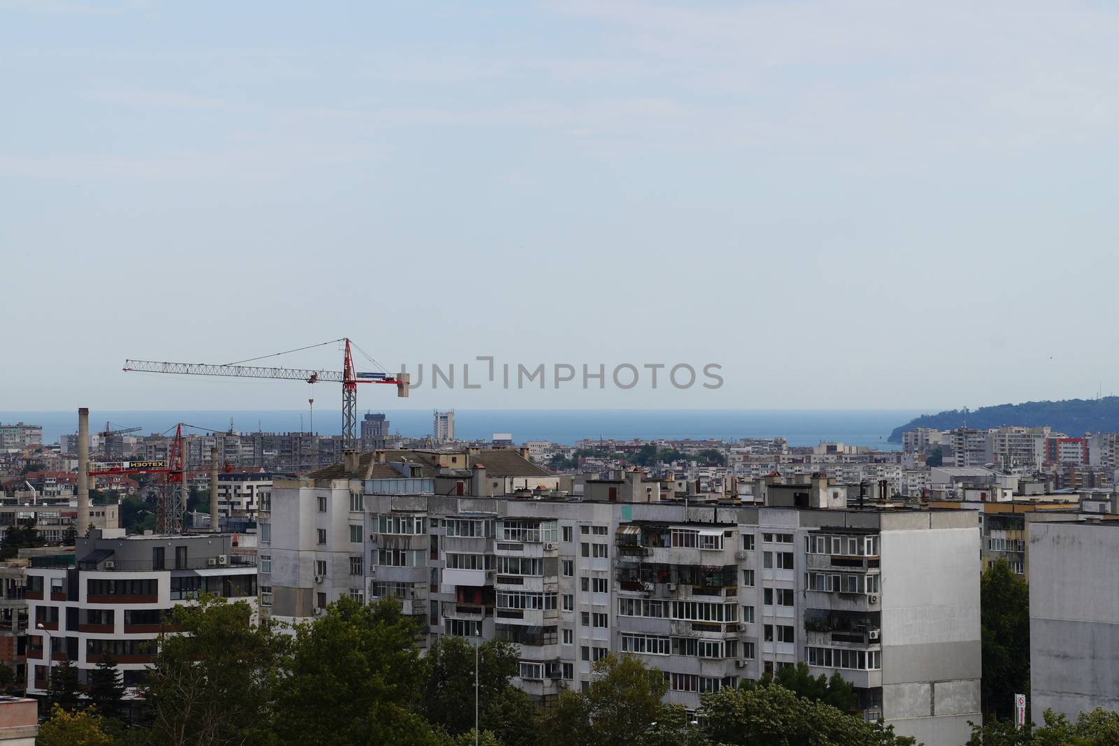 urban area on the background of the sea on a rainy day, top view by Annado