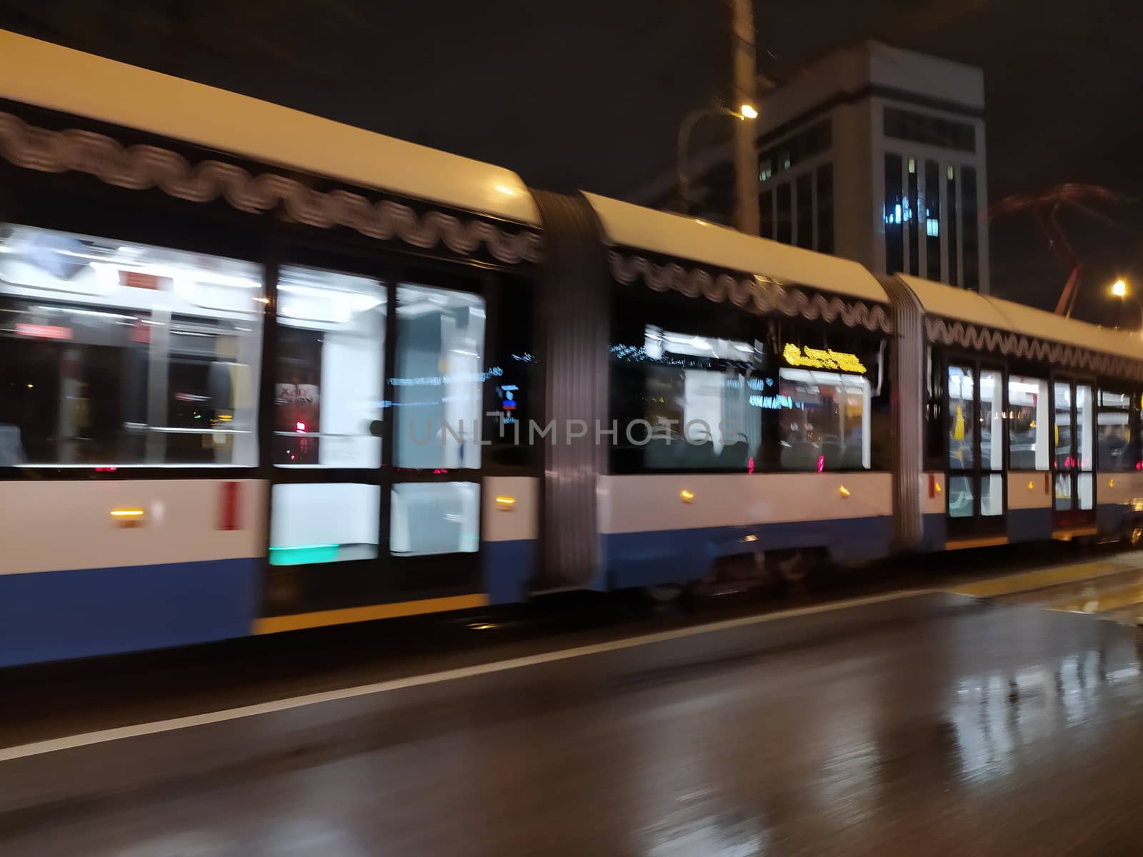 motion blurred empty night train in rainy weather by Annado