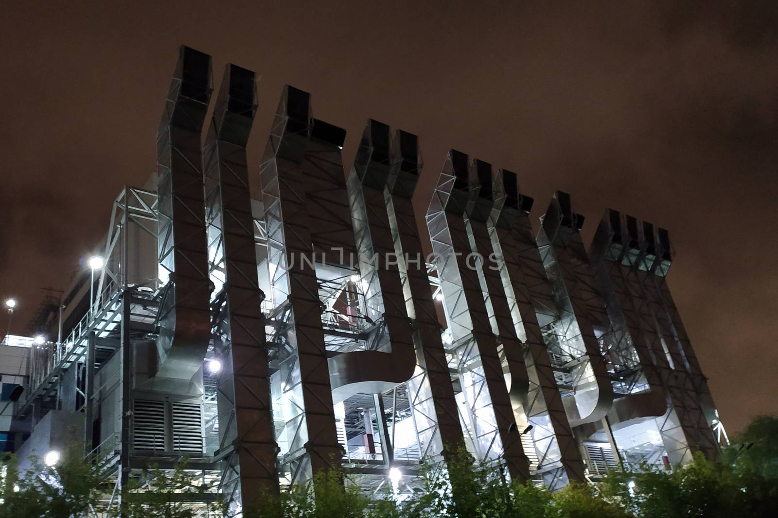 factory ventilation on the facade of the building in the evening.