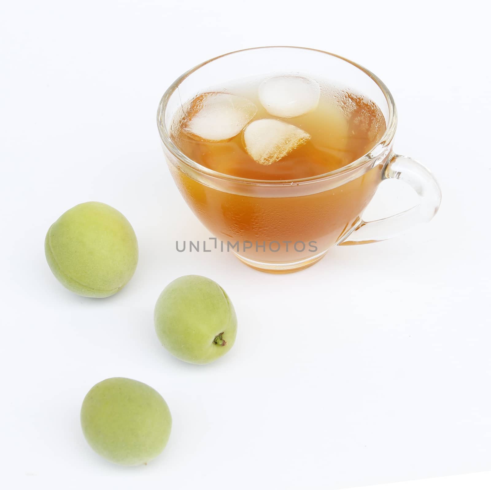 A cup of cold green tea with plum by uphotopia