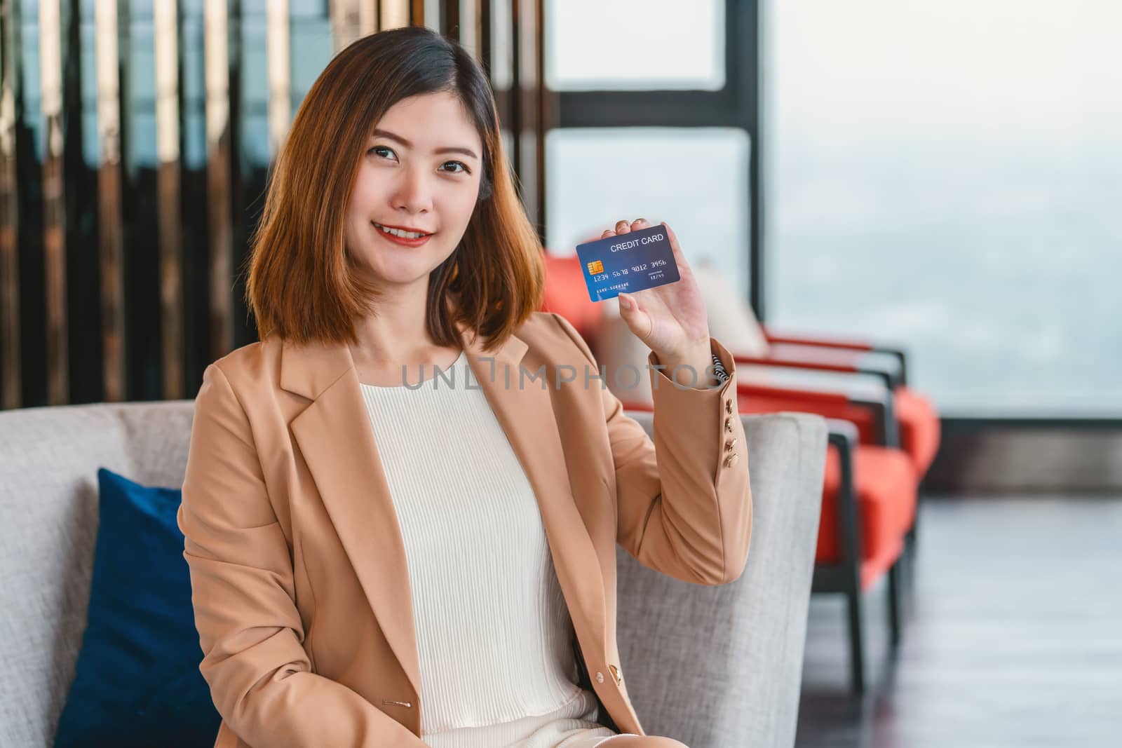Portrait Asian woman presenting the credit card for online shopp by Tzido