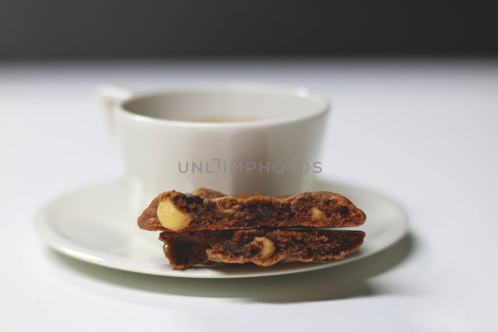 Cookie and cup of coffee on table by uphotopia