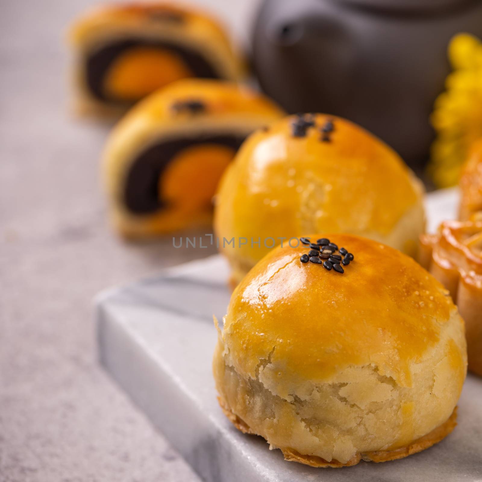 Tasty baked egg yolk pastry moon cake for Mid-Autumn Festival on by ROMIXIMAGE