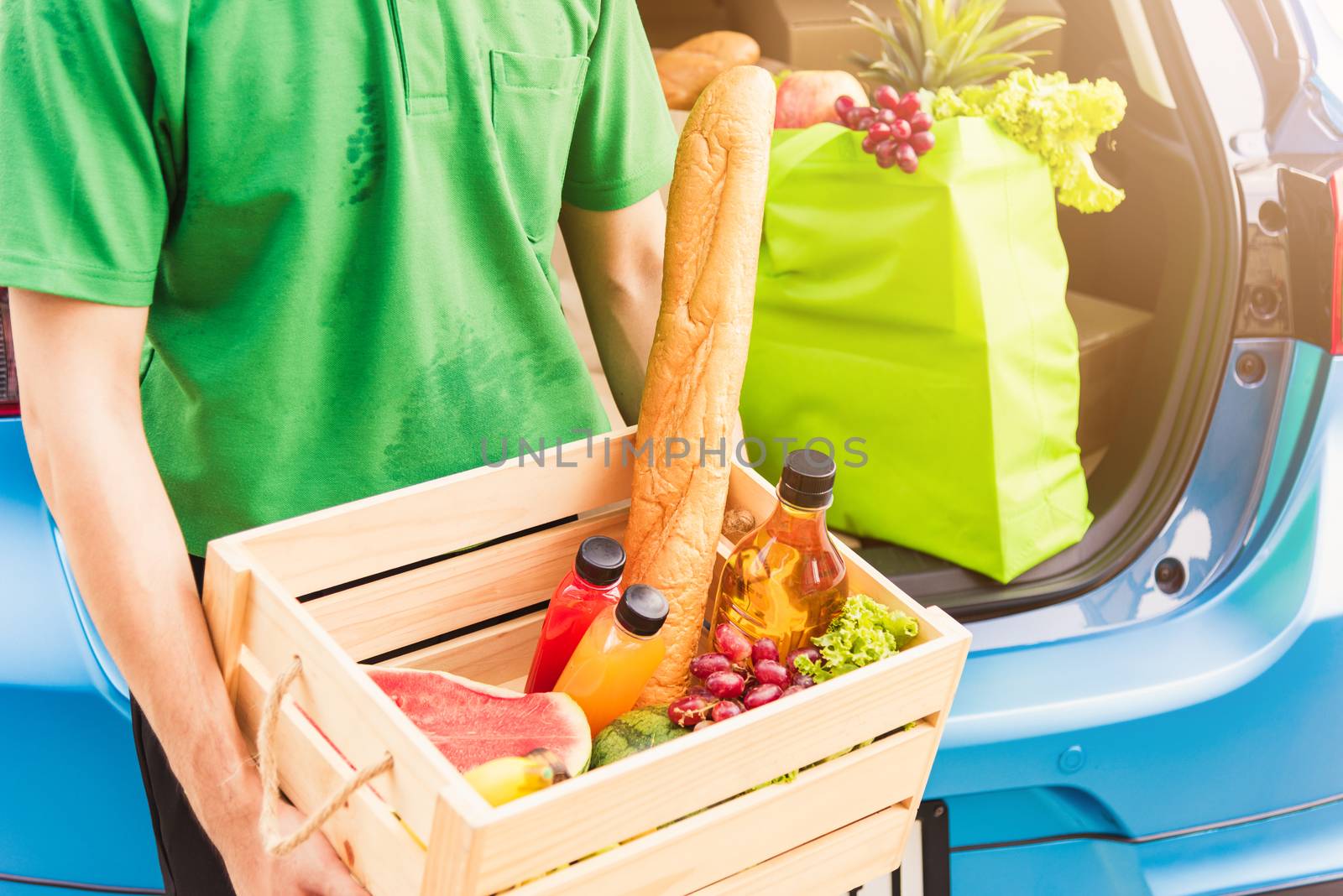 Delivery man grocery prepare fresh vegetables food in wooden bas by Sorapop
