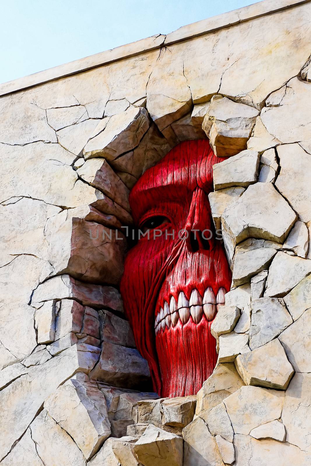 Osaka, Japan - Feb 6 2015 : Life size scale Statue of Wall giant from Attack on Titan (Shingeki no Kyojin) at Universal Studios Japan.