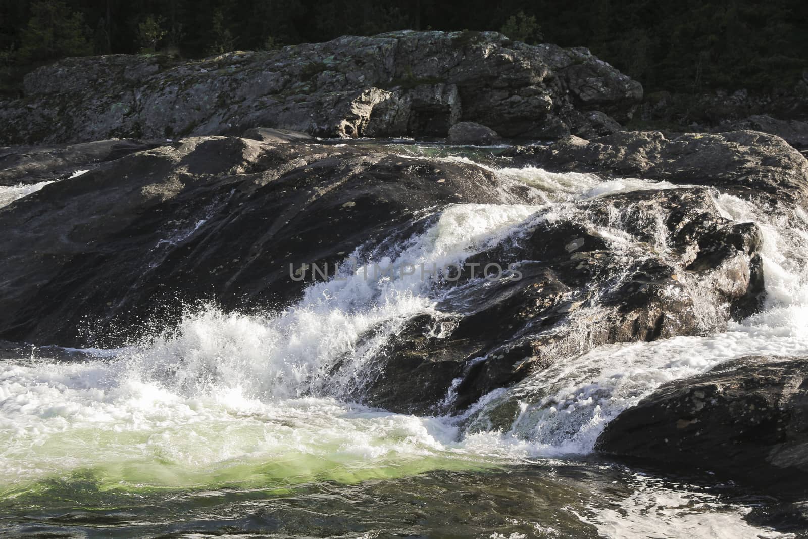 Fast flowing river water of the waterfall Rjukandefossen in Hemsedal, Buskerud, Norway.