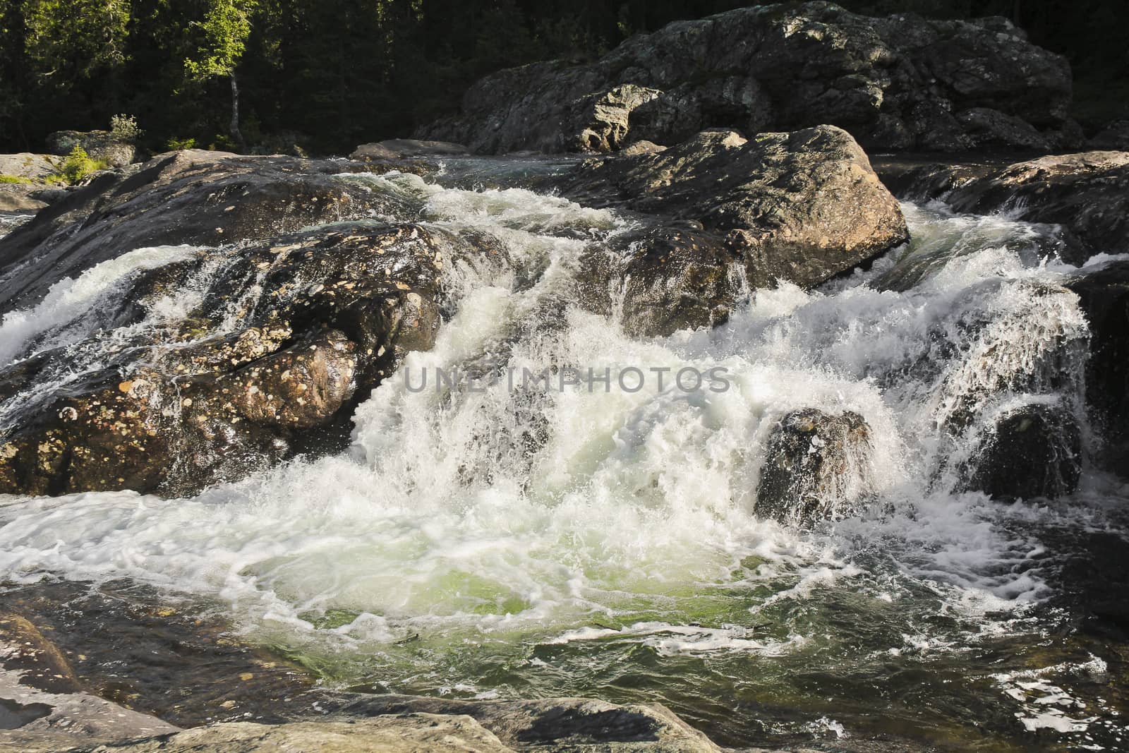 Fast flowing river water of waterfall Rjukandefossen, Hemsedal, Buskerud, Norway. by Arkadij