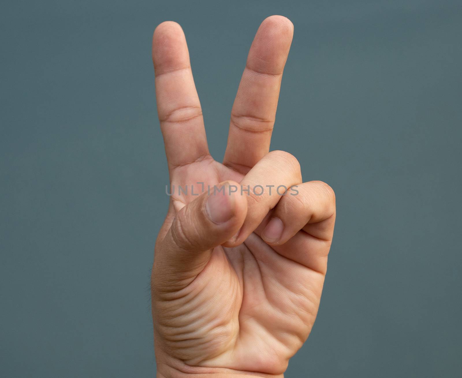 Two fingers raised on blue back ground. symbol concept.