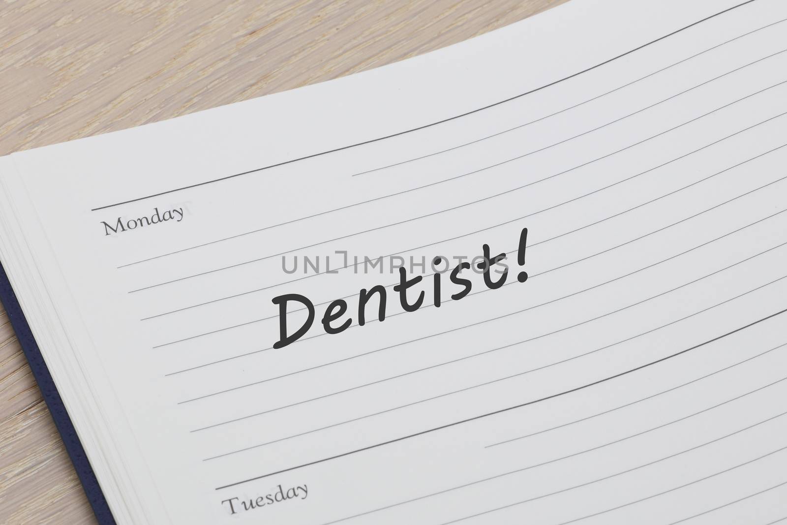 Dentist appointment diary reminder open on desk by VivacityImages