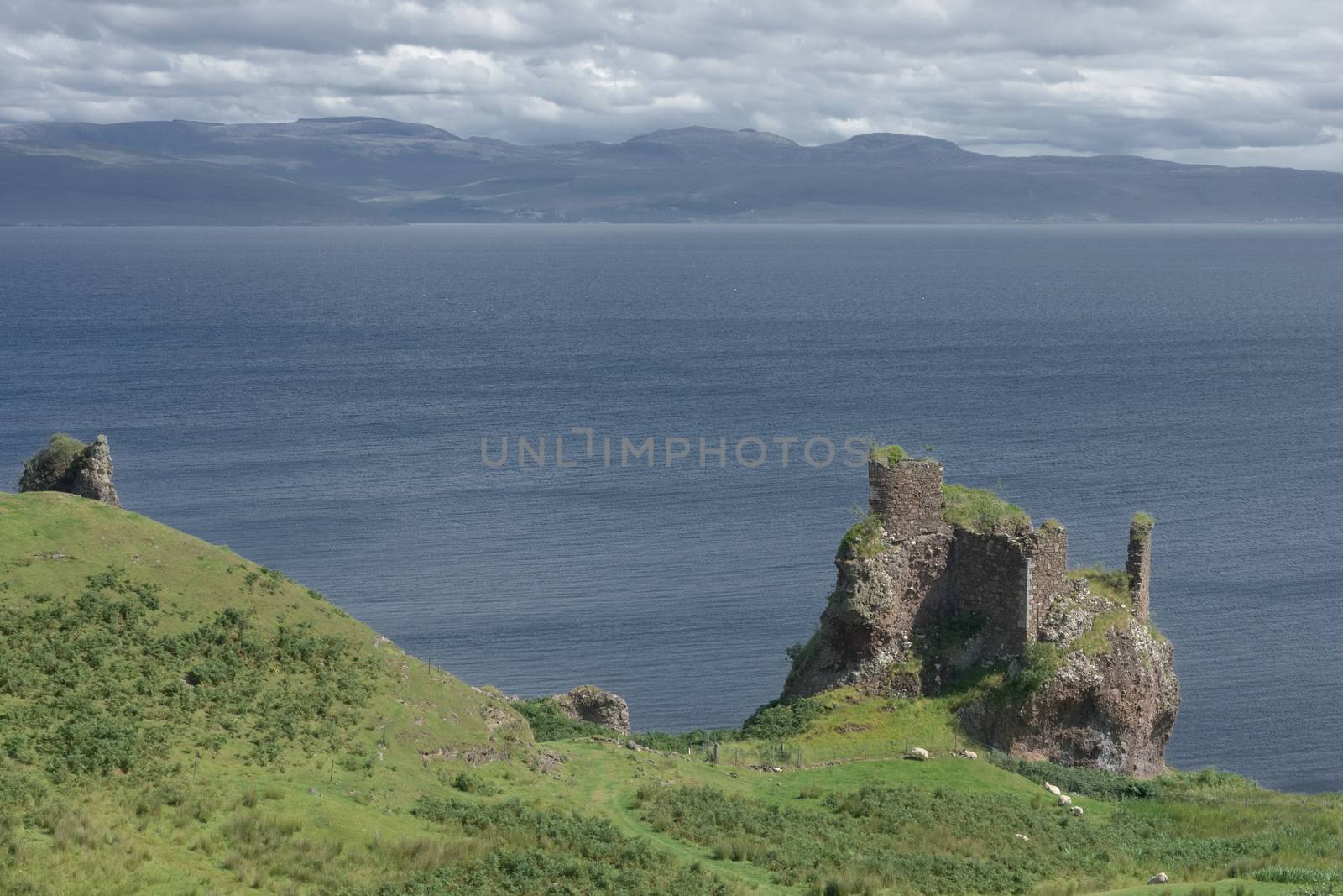 Old ruined coastal castle, brochel castle, on the shores of the inner sound and isle of Raasay in scotland. Sunny day with a cloudy sky.