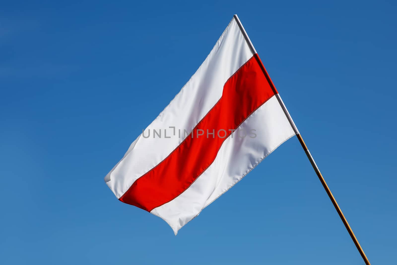 White-red-white flag on blue sky background. Historical Belarus authentic flag.