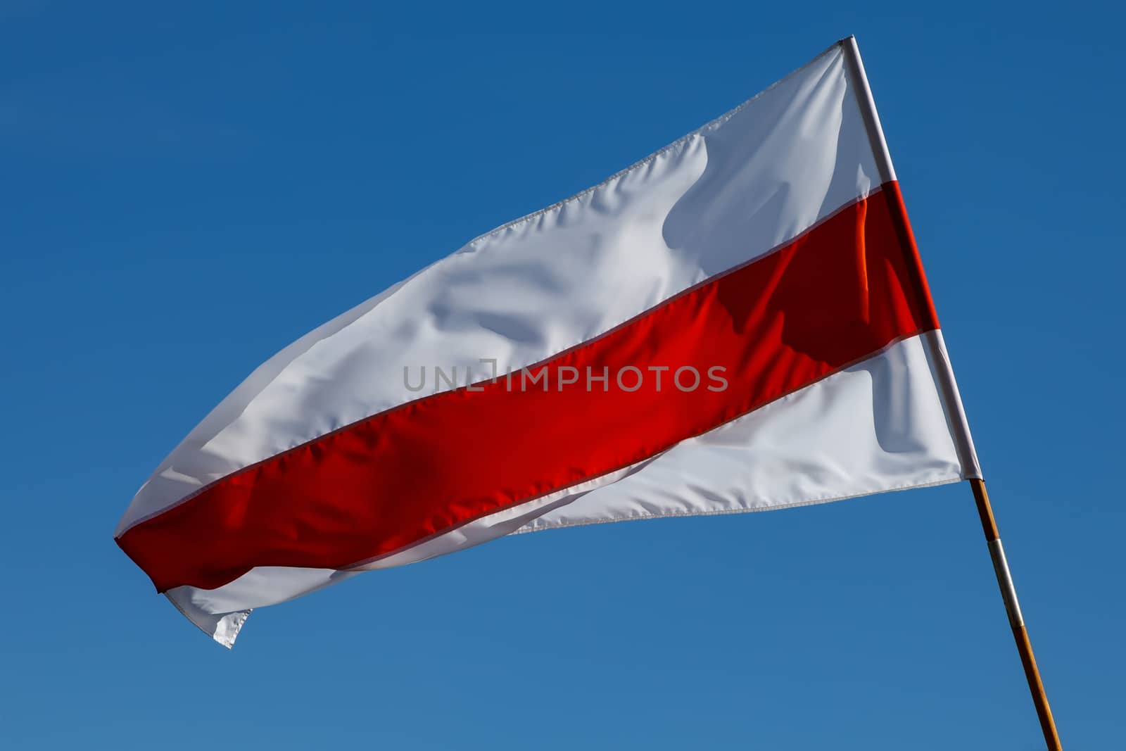 White-red-white flag on blue sky background. Historical Belarus authentic flag.