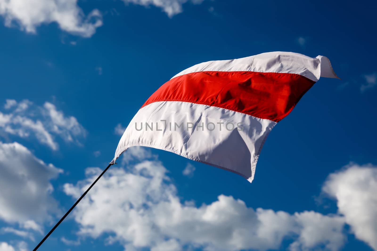 White-red-white flag on blue sky background. Historical Belarus authentic flag.