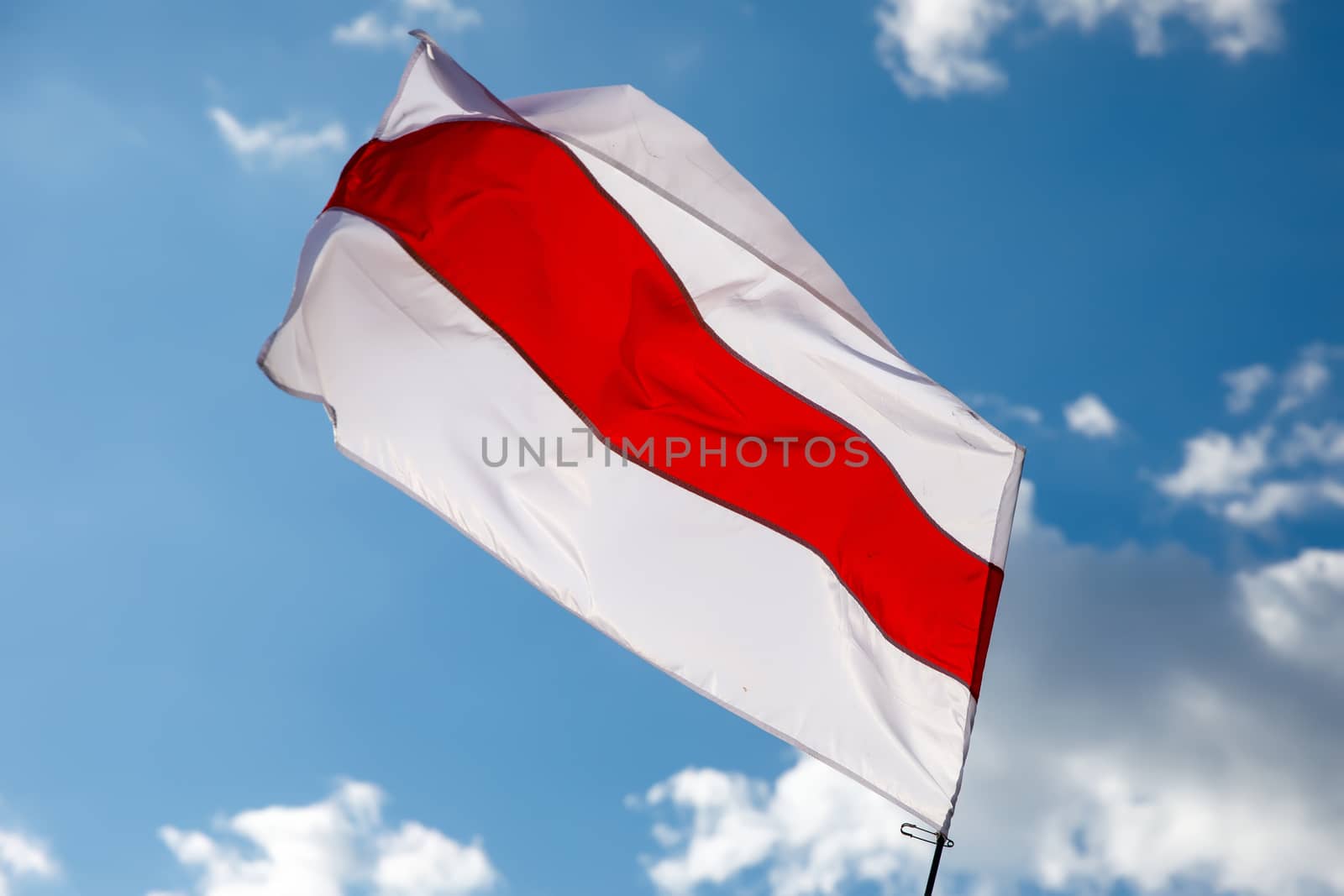 White-red-white flag on blue sky background. Historical Belarus authentic flag.