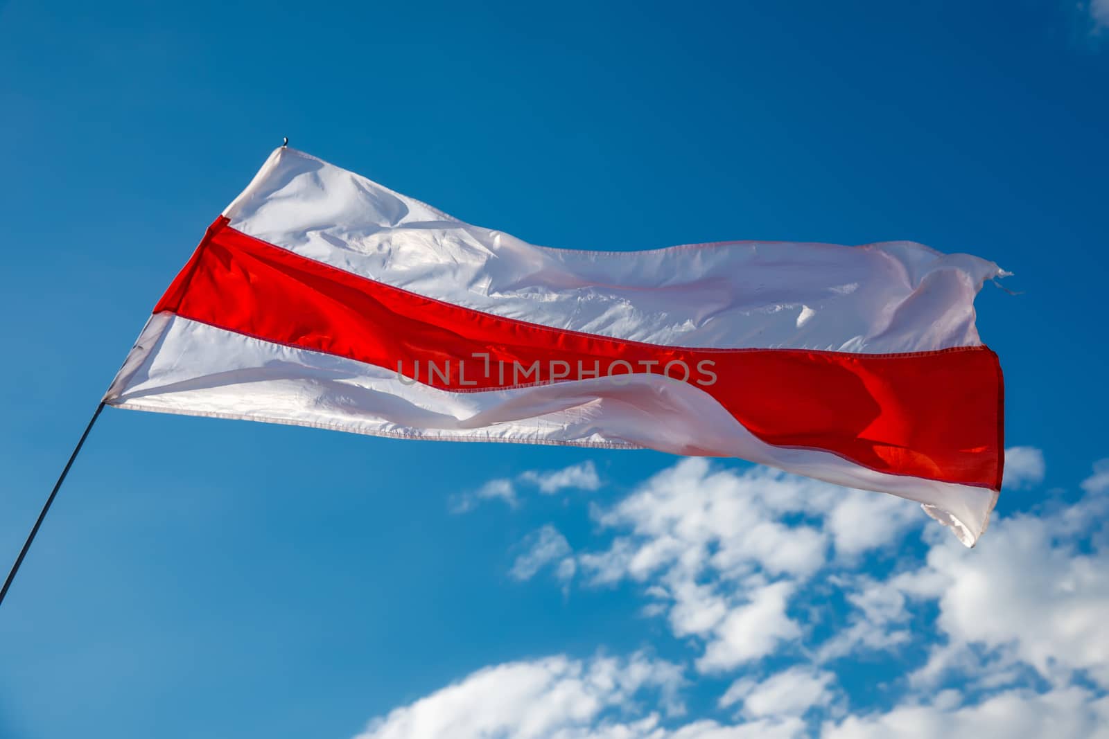 White-red-white flag on blue sky background. Historical Belarus authentic flag.