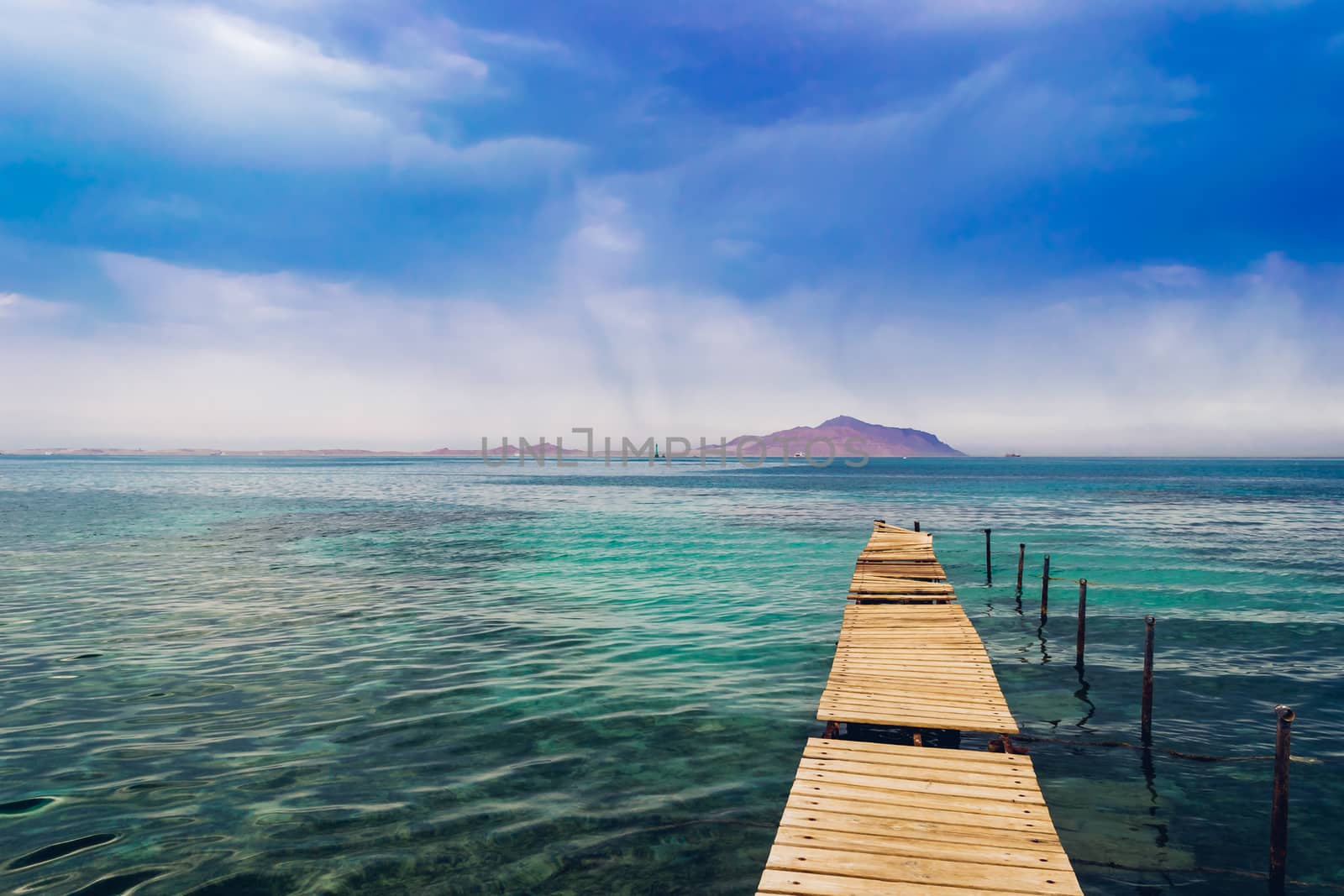 Old wooden pier on the Red sea at overcast day