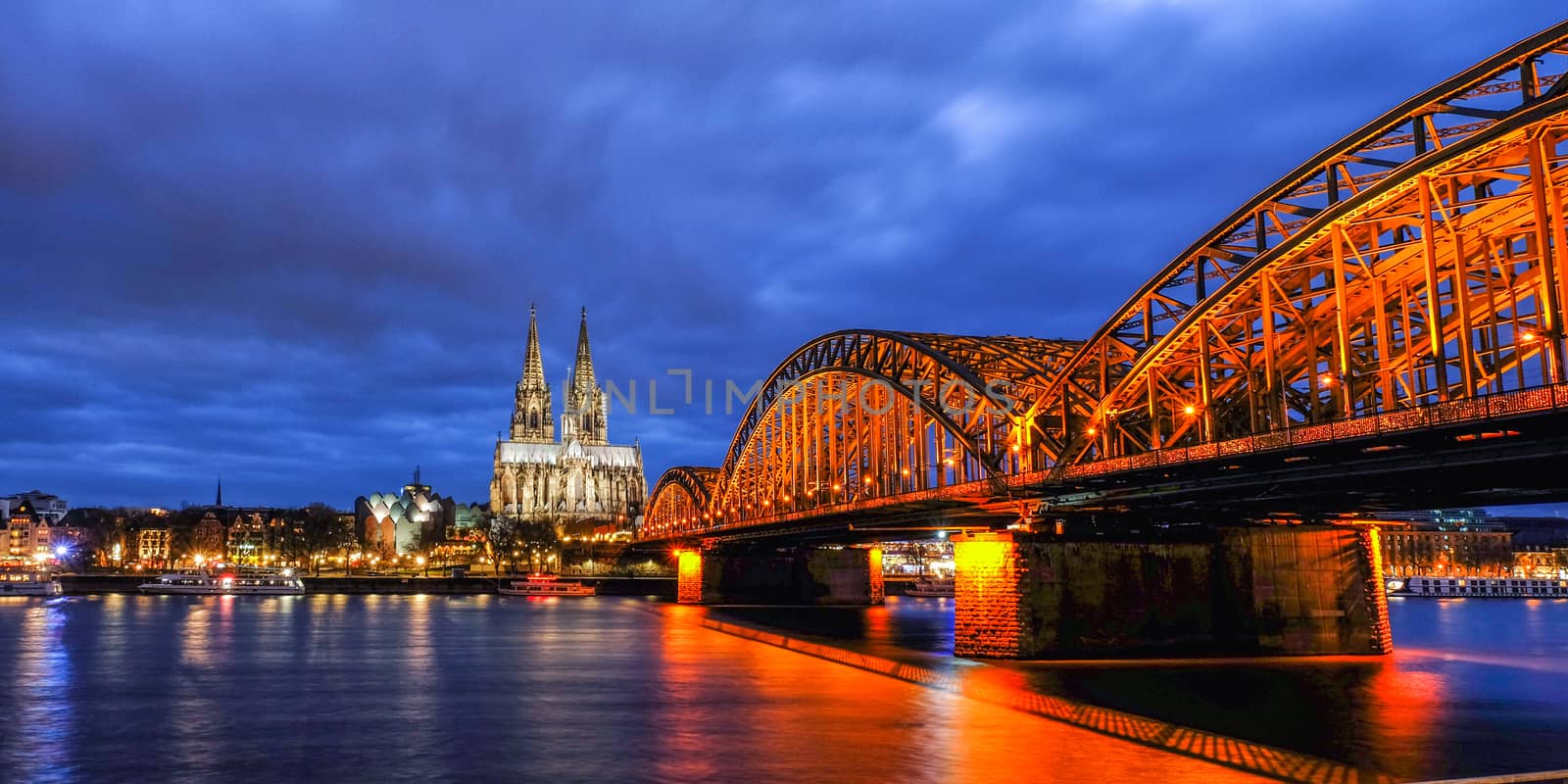 Cologne Cathedral and Hohenzollern Bridge at Twilight Time in Ge by Surasak