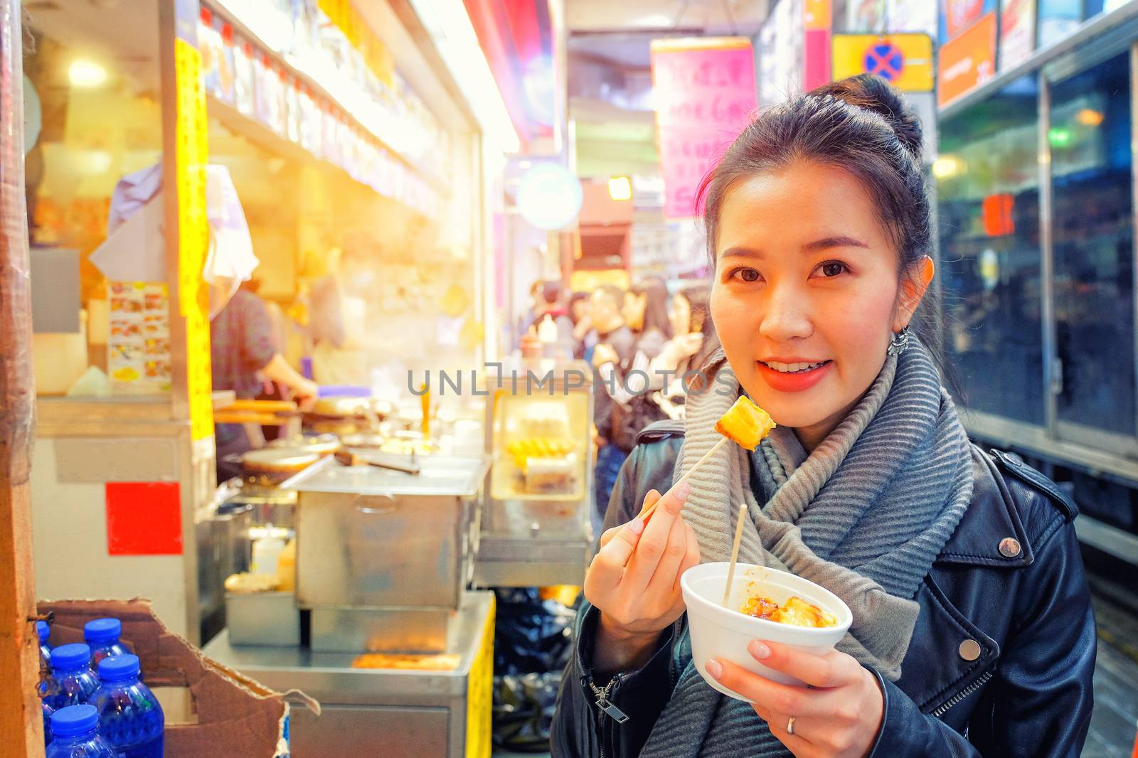Chinese Asian young female model eating Chinese Steamed Dumpling on Street in Hong Kong